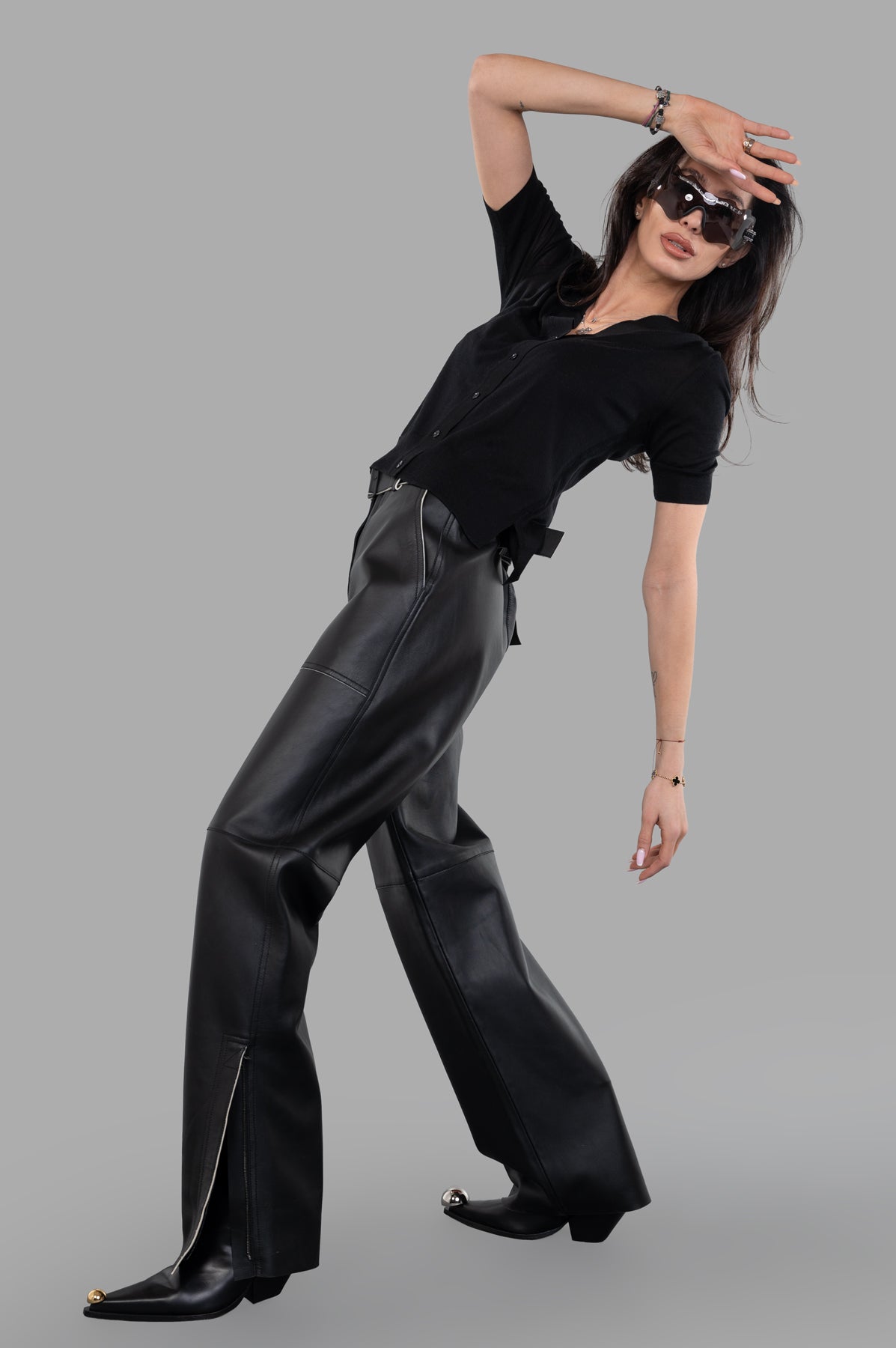 Joseph Nappa Leather Trousers on model, featuring wide, tapered-leg design, buckled belt, and covered hem zips.