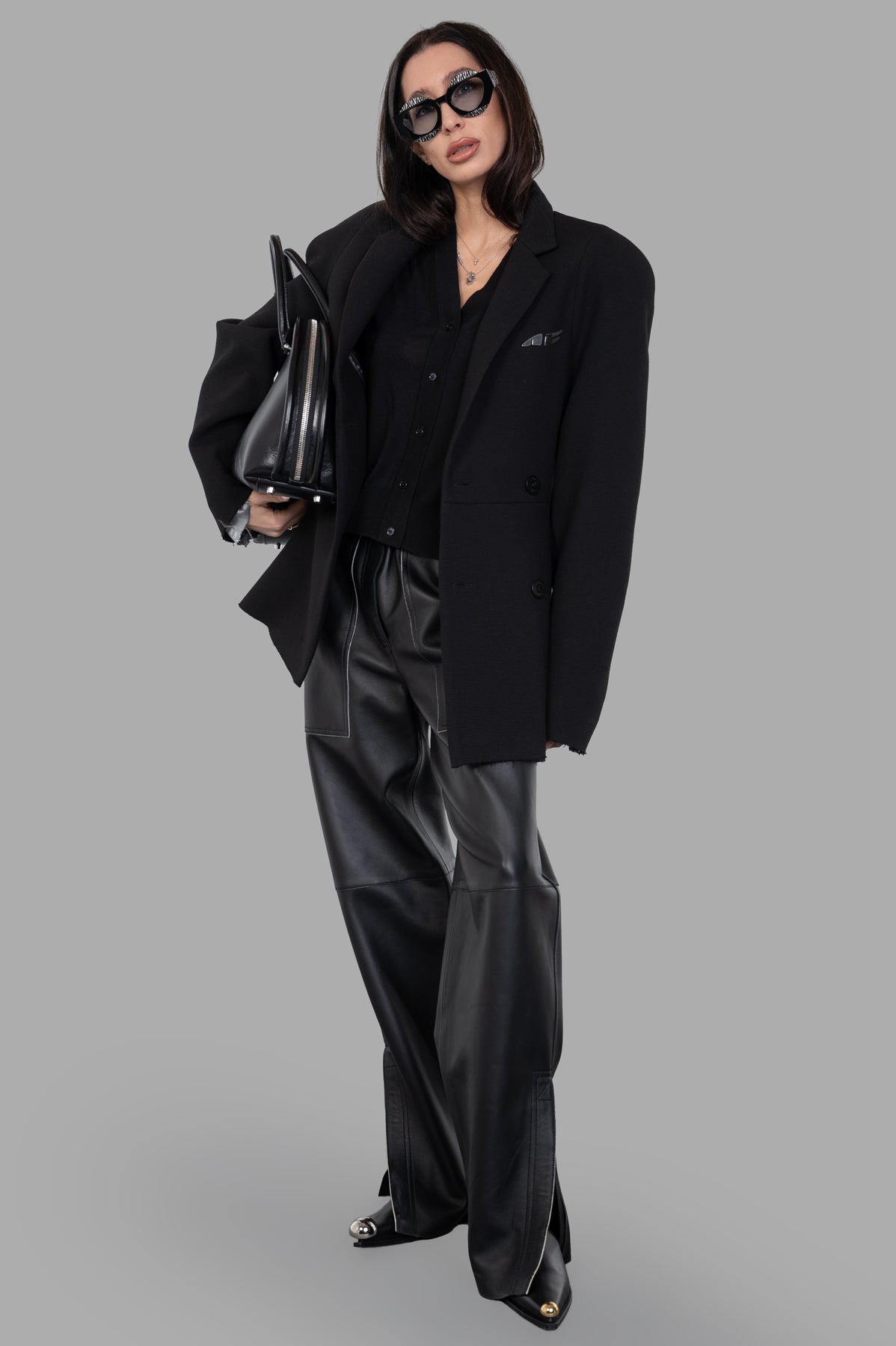 Natasha Zinko Pilot Jacket in black, front view with double-breasted closure, oversized fit, and logo detail.