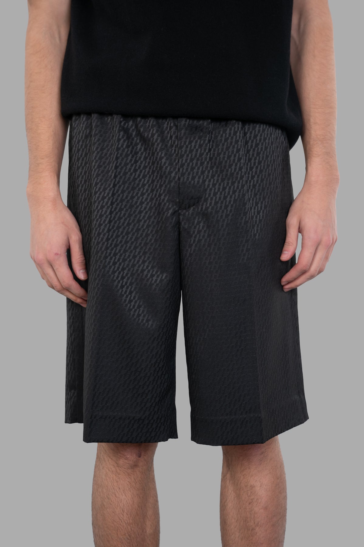 Helmut Lang Jacquard Car Shorts in black showcase a sleek satin jacquard texture and straight leg cut worn by a model.