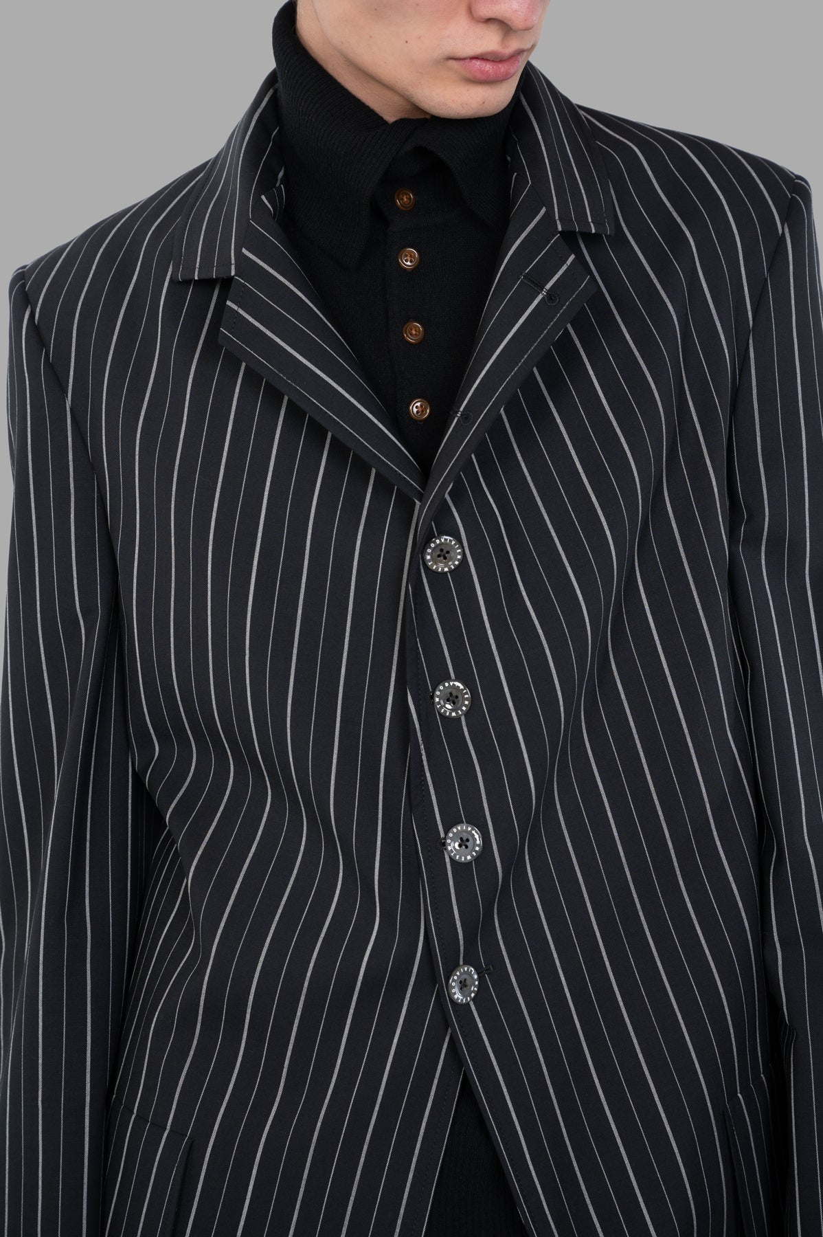 Vivienne Westwood DL Pinstripe Jacket close-up showcasing classic black pinstripe pattern, statement lapel, and engraved buttons.