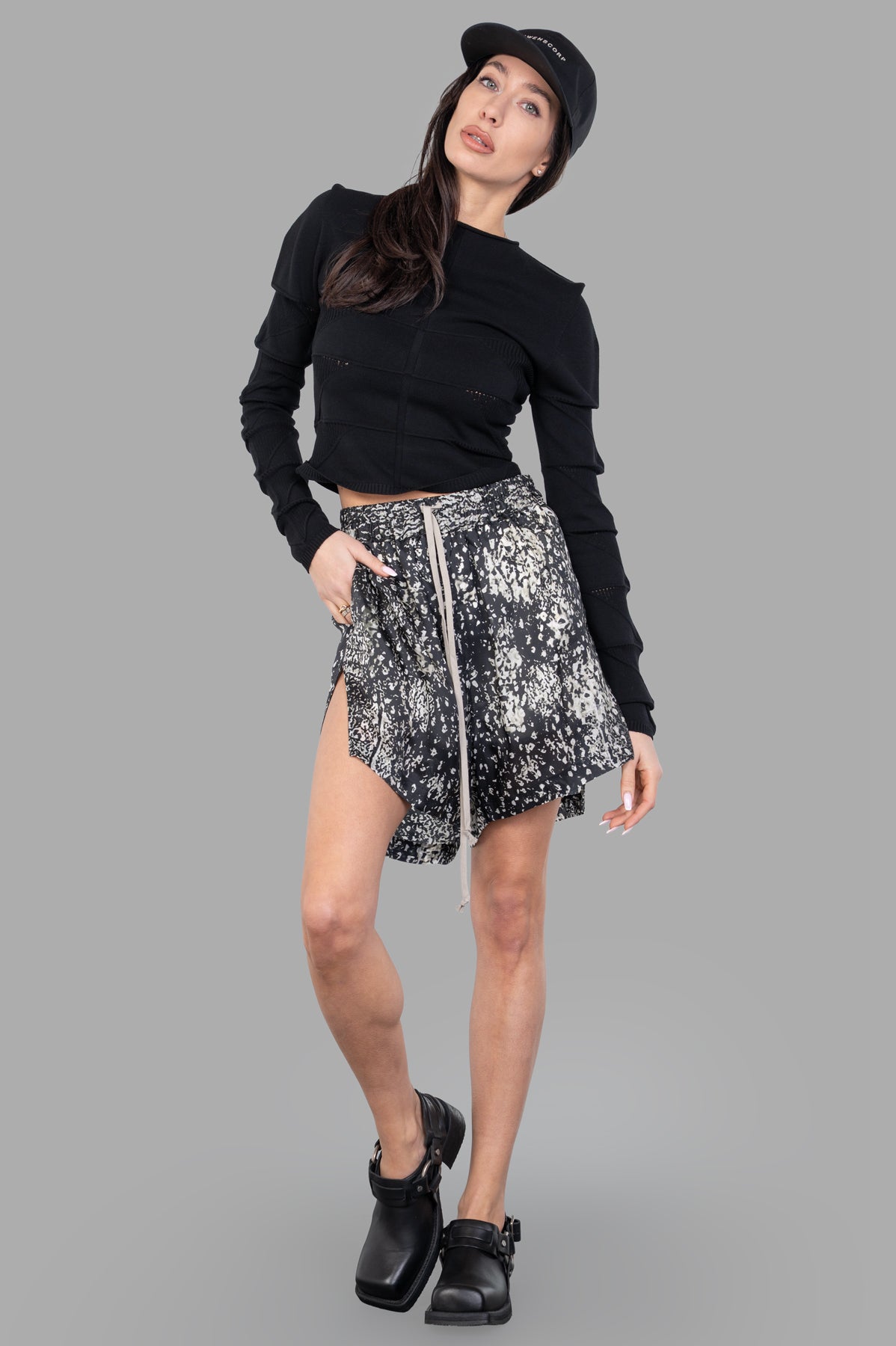 Rick Owens Cropped Knit Blouse, black, on-model view; paneled design, long sleeves, sleek fit, paired with stylish skirt.