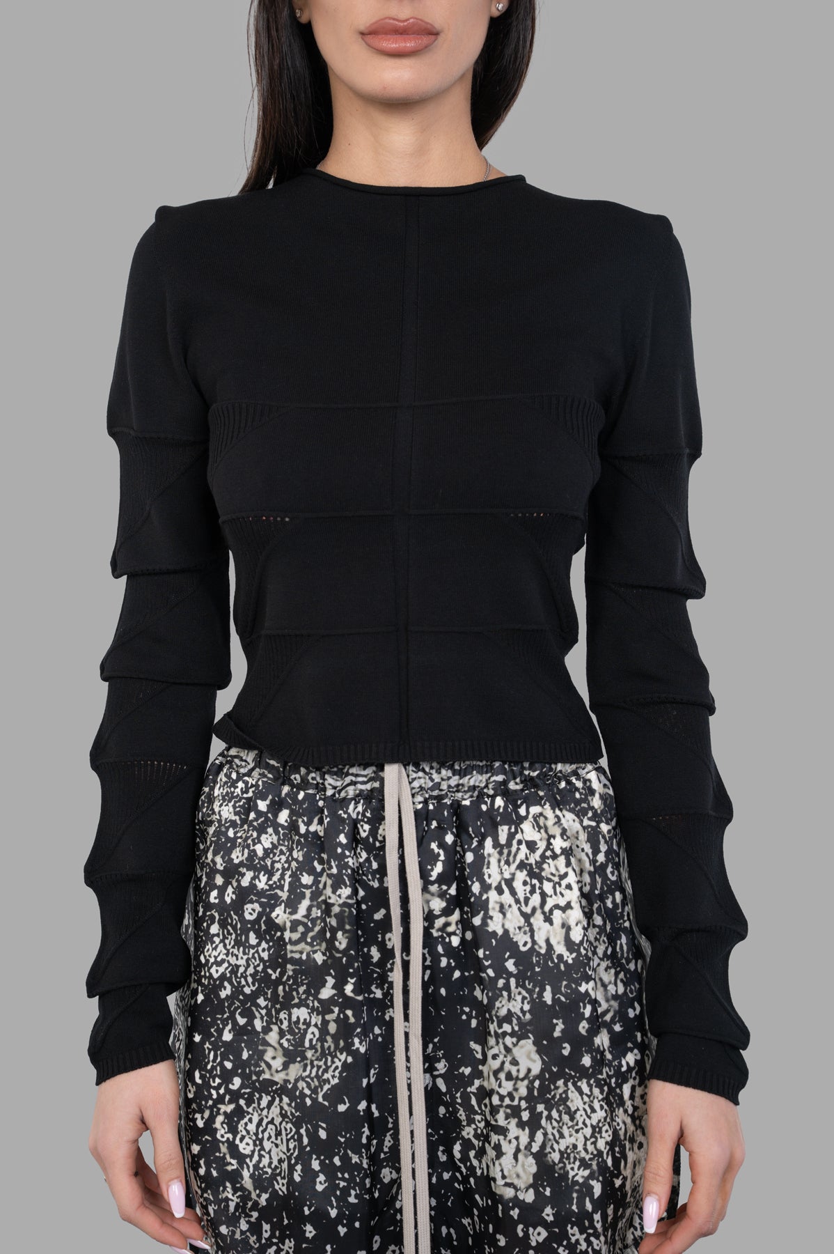 Rick Owens Cropped Knit Blouse in black, showcasing intricate detailing and a fitted design on model's upper body.