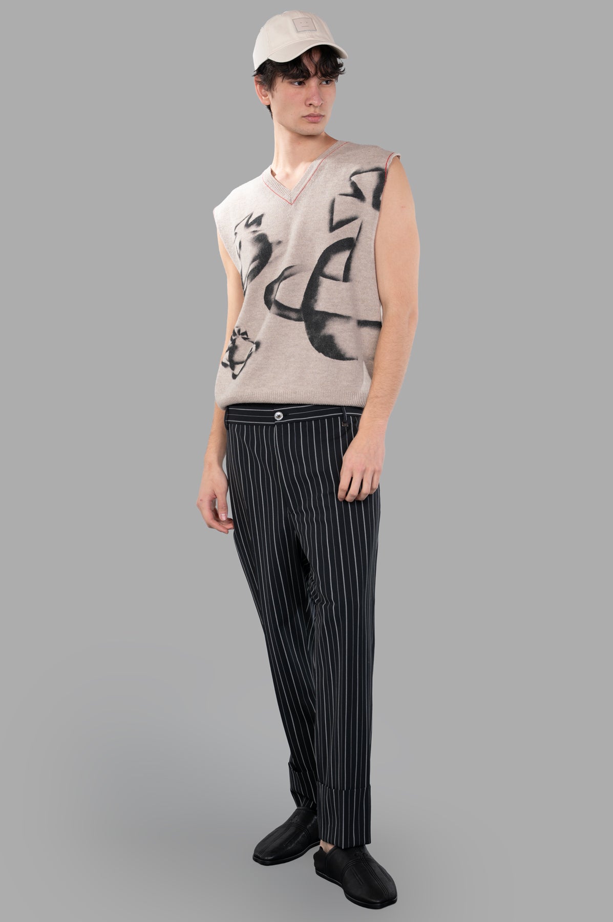 Vivienne Westwood Orbit Vest in beige, front view on model, features v-neck design and elegant contrast stitching.