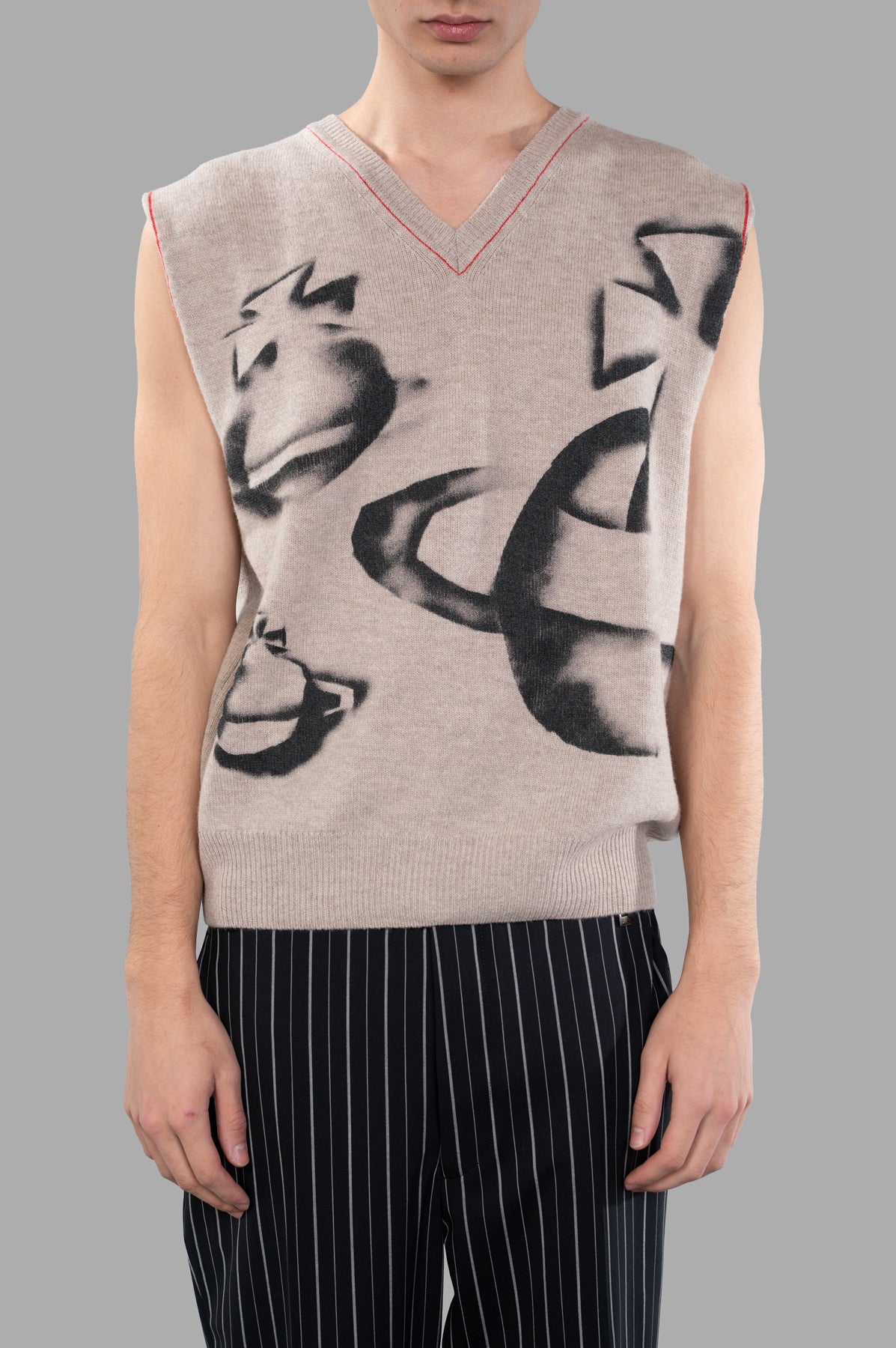 Vivienne Westwood Orbit Vest featuring a classic v-neck, sleeveless design, and unique graphic in almond beige worn on model.