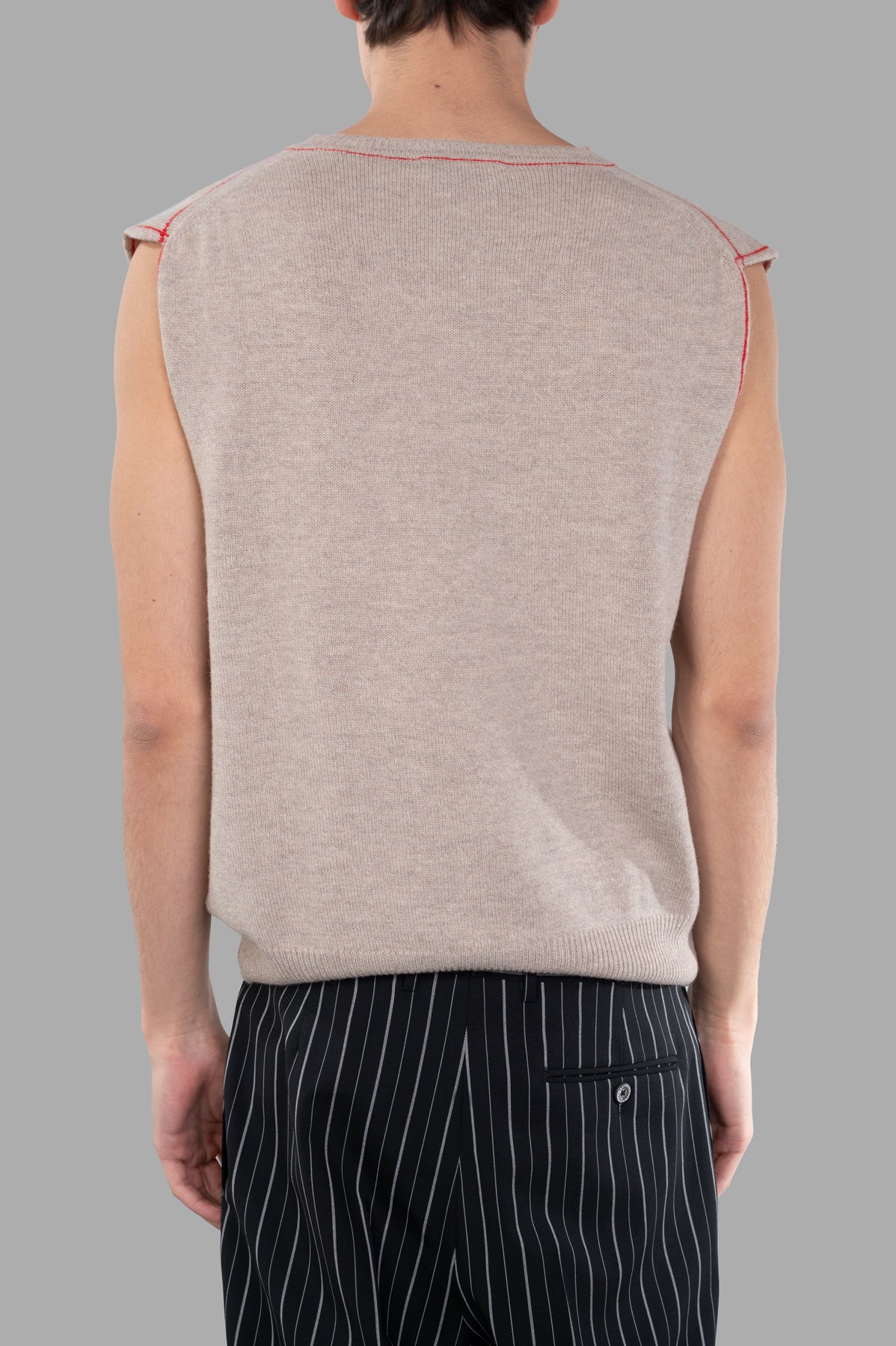 Vivienne Westwood Orbit Vest shown from the back, featuring a sleek almond beige design with contrast stitching.