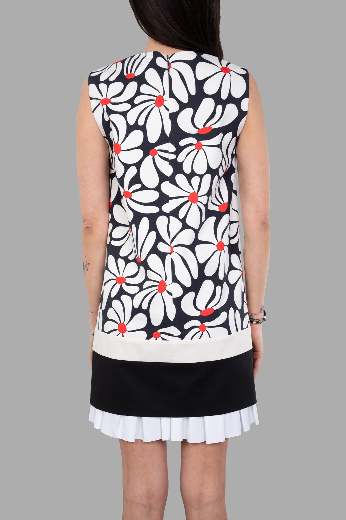 MSGM Floral Dress featuring a playful floral print, pleats, and an above-the-knee length, shown from the back.