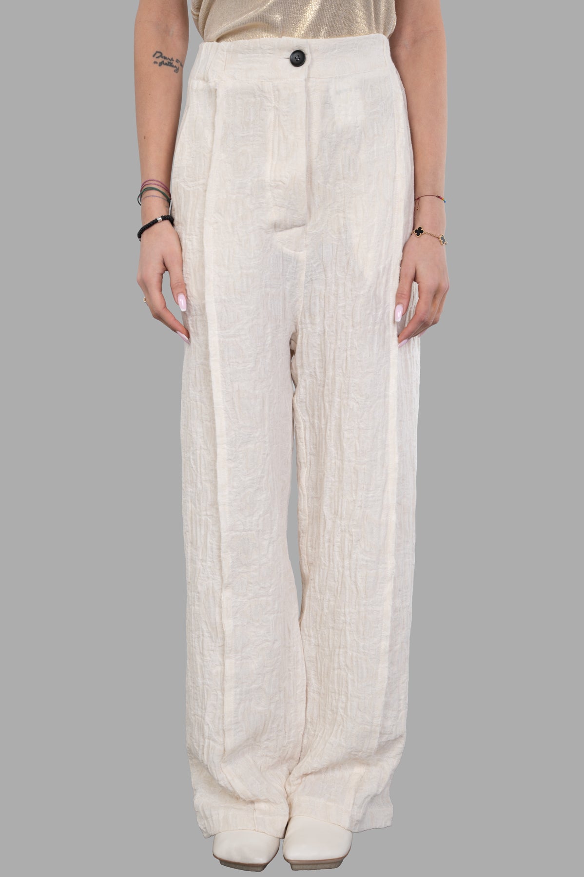 Marc Point Textured Trousers in cream, showcasing high-waisted, drop-crotch design with distinctive texture, front view.