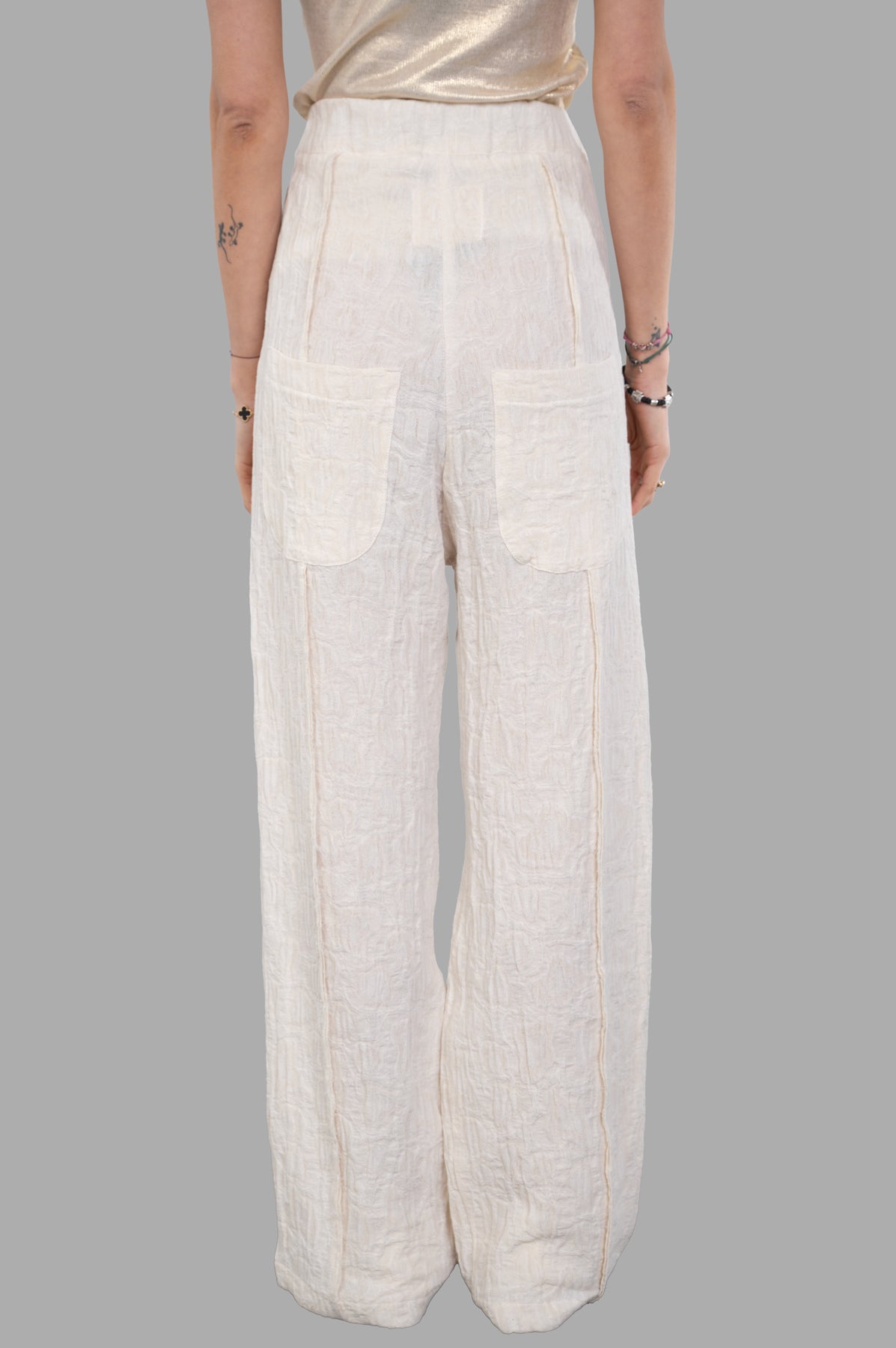 Marc Point Textured Trousers in cream, featuring high-waisted drop-crotch design and unique texture, shown from the back.
