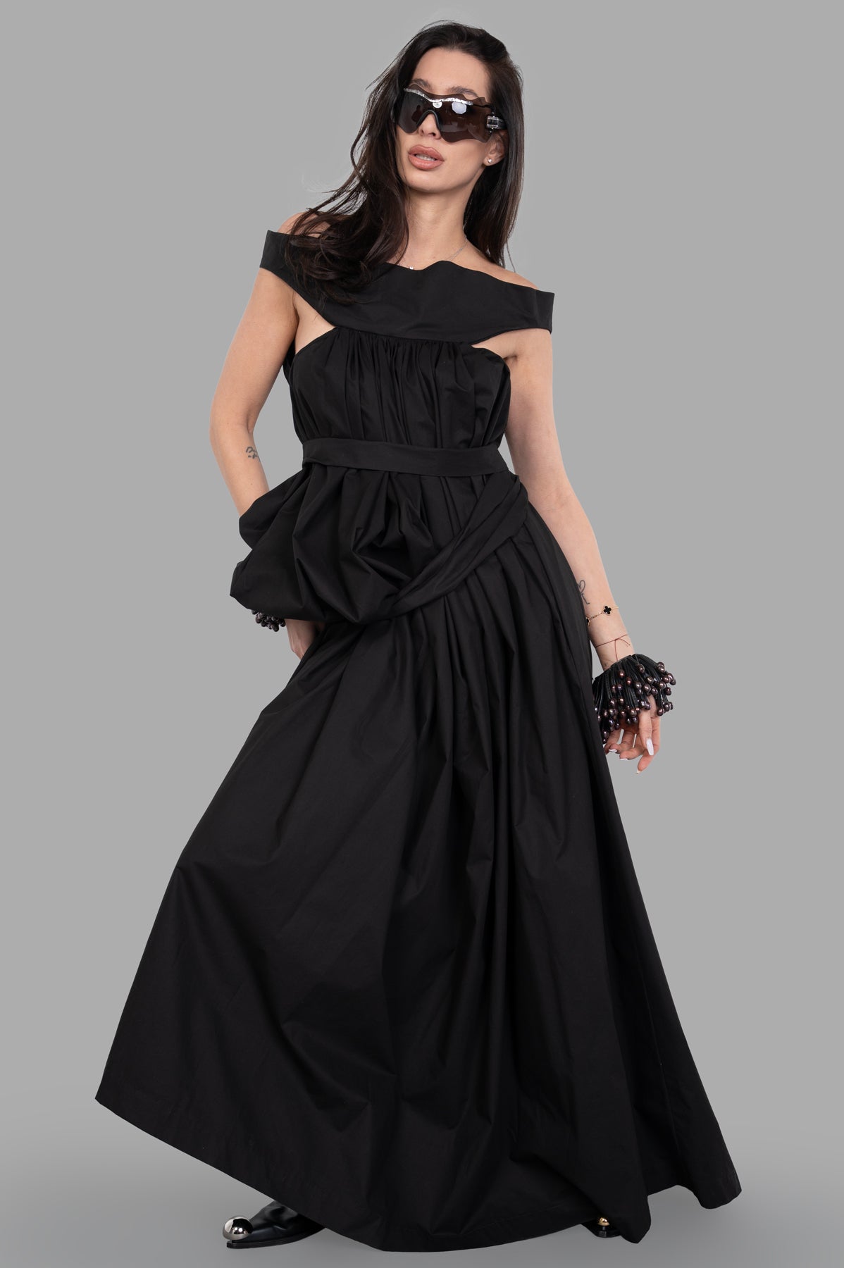 Rick Owens Hollywood Chalice Gown in black, model wearing belted gown with wide square collar and pleated design.