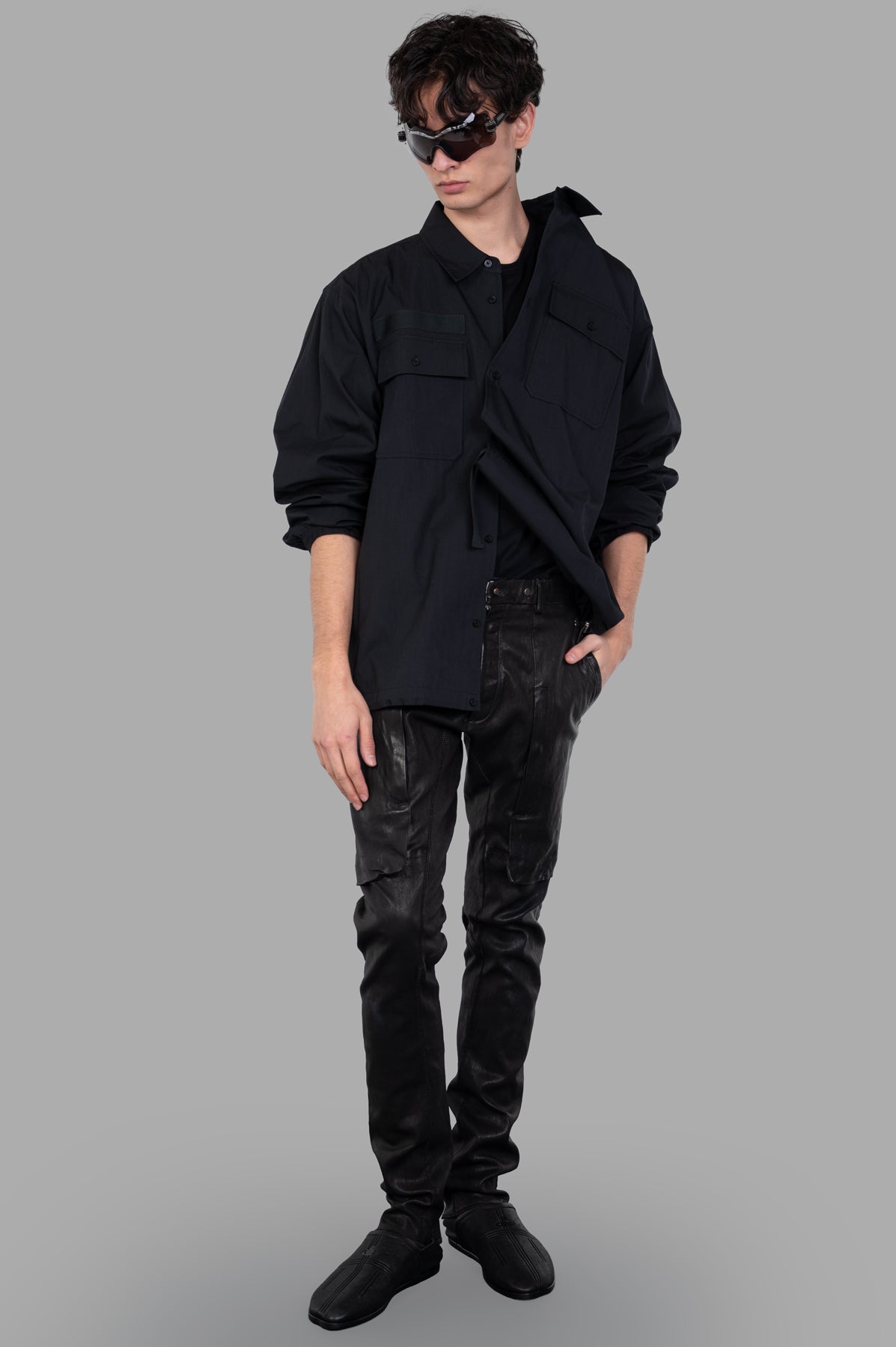 Helmut Lang Uniform Shirt in black, front view on model, featuring a button-down design with a bungee-cord hem.