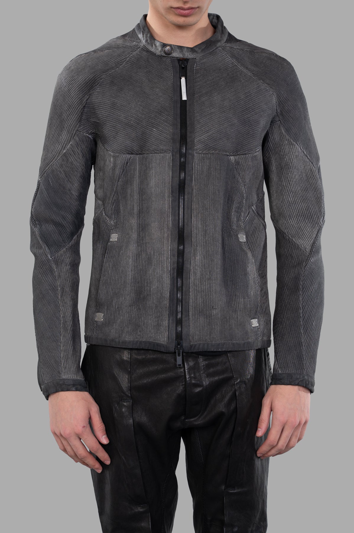 Isaac Sellam Musculaire Jacket in grey features a bold front zip, textured leather, and inset pockets displayed on model.
