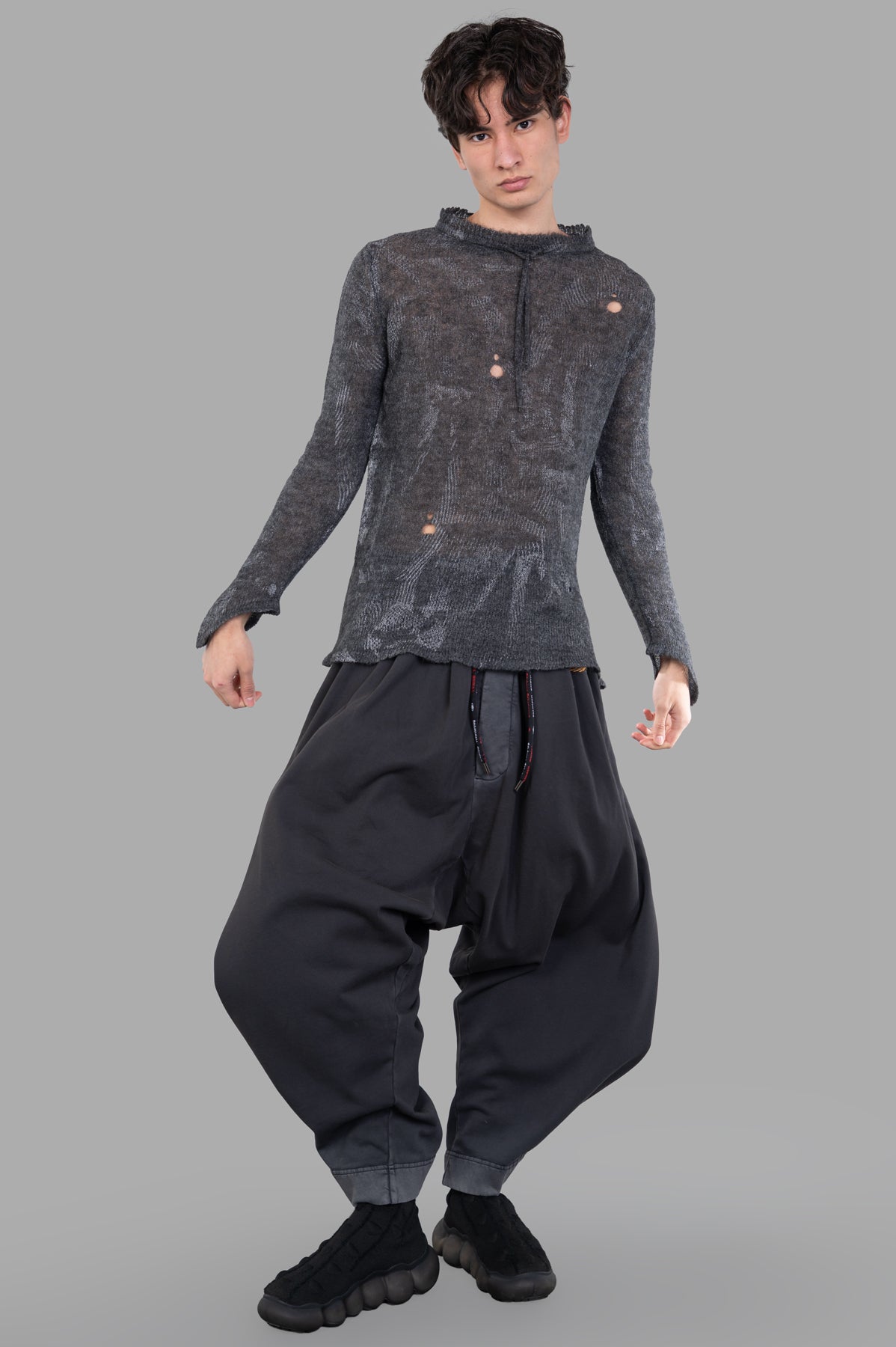 Vivienne Westwood Hi-Vis Jumper in grey alpaca blend, worn by model front view, features raw edges and contrast print.