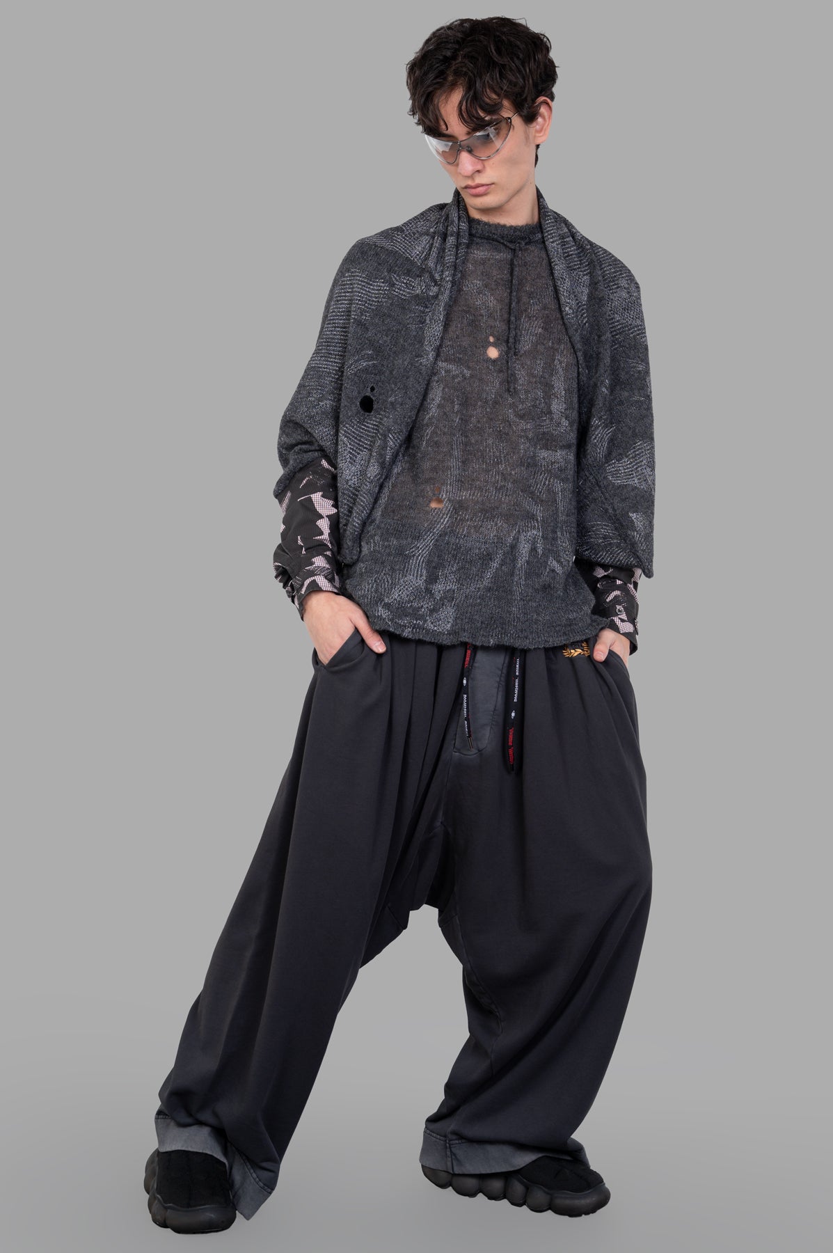 Vivienne Westwood Hi-Vis Poncho Scarf in grey alpaca-blend on model, featuring Ermine Flower motif and buttoned cuffs.