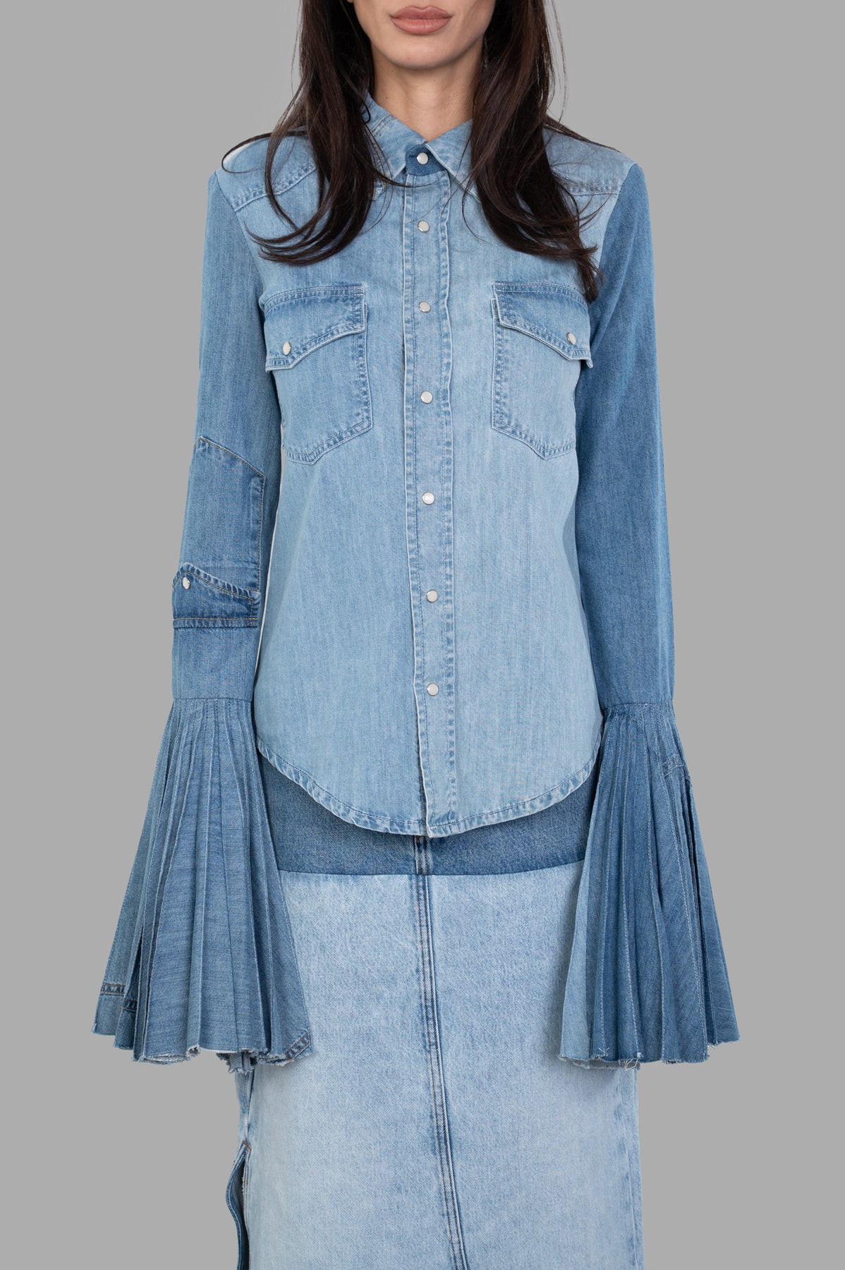 A.W.A.K.E. MODE Denim Shirt With Pleated Sleeves, featuring a structured fit and bold pleated cuffs, shown front view in blue.