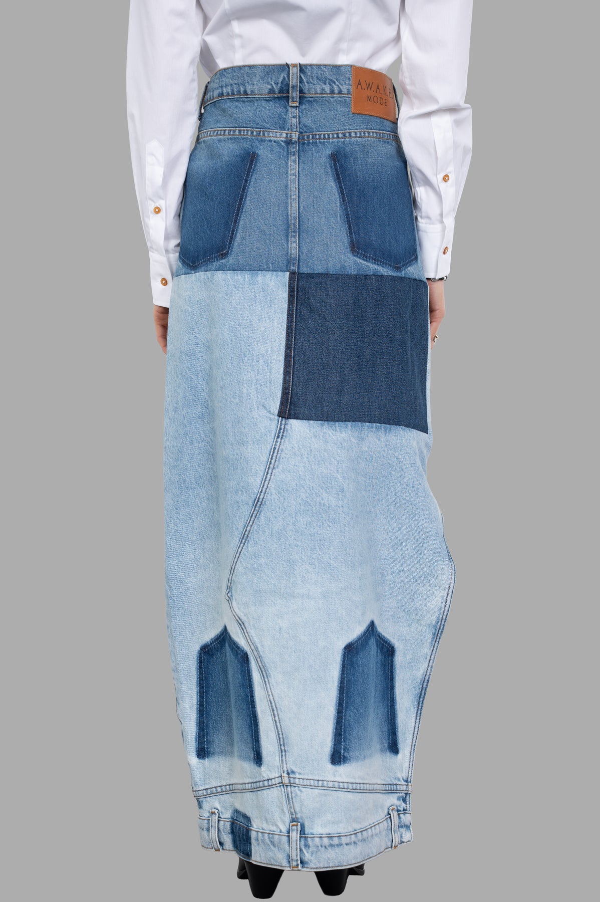 A.W.A.K.E. MODE Mirror-effect Skirt featuring a unique patchwork design with a soft denim texture, displayed from the back.