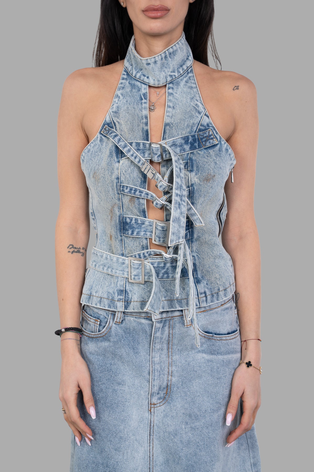 Natasha Zinko Treated Strapped-in Top featured on a model, showcasing a denim halter design with unique lace-up details.