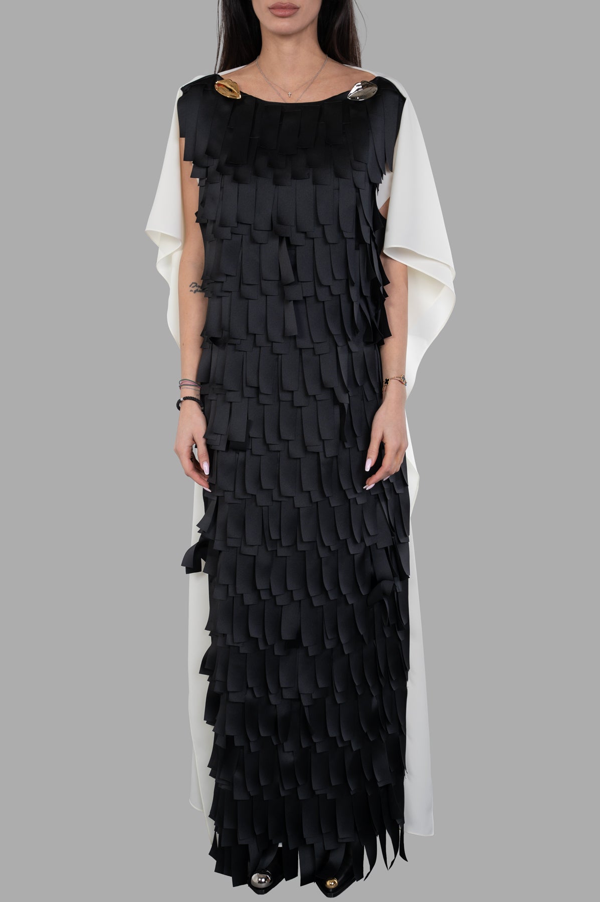 A.W.A.K.E. MODE Laser-cut Satin & Twill Gown featuring a textured black overlay and elegant white draped cape effect on.