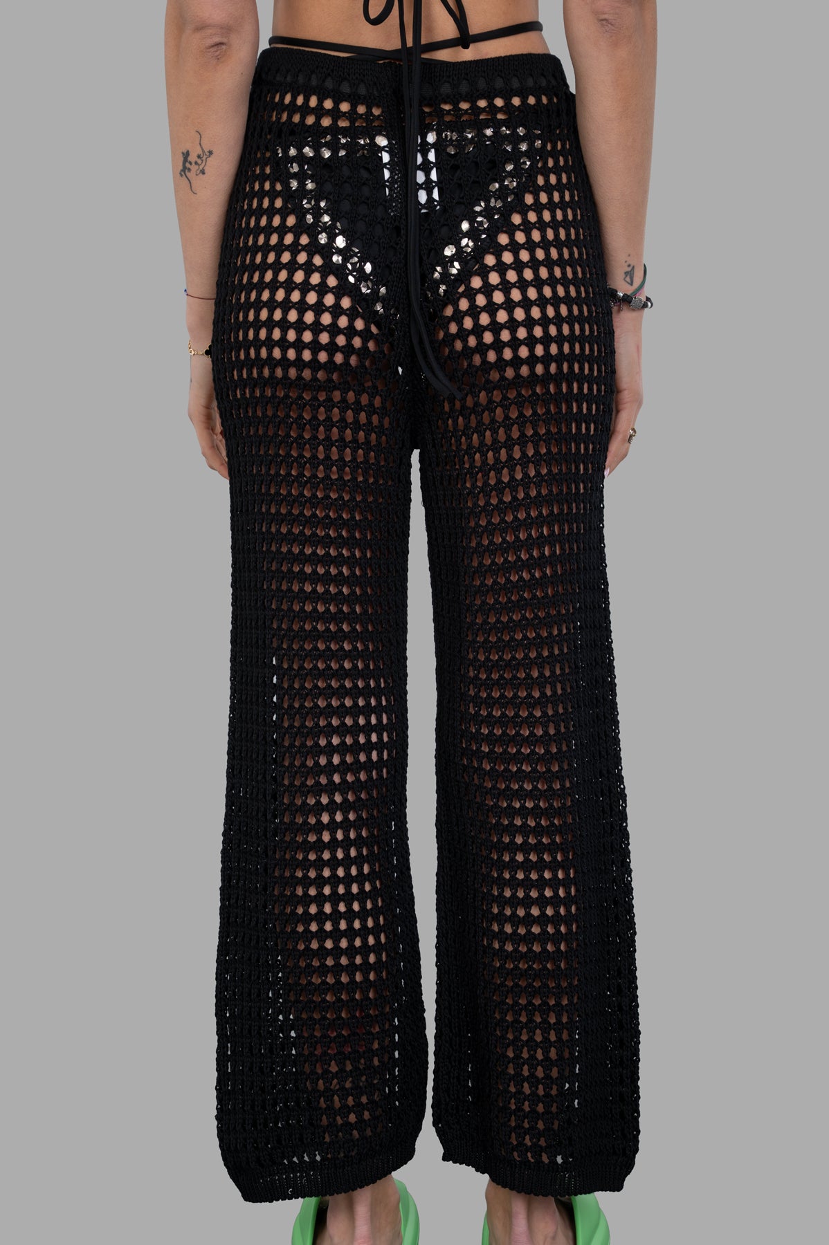 Marc Point Beach Cover-Up Pants shown on model from the back, featuring a stylish open knit design and relaxed fit.