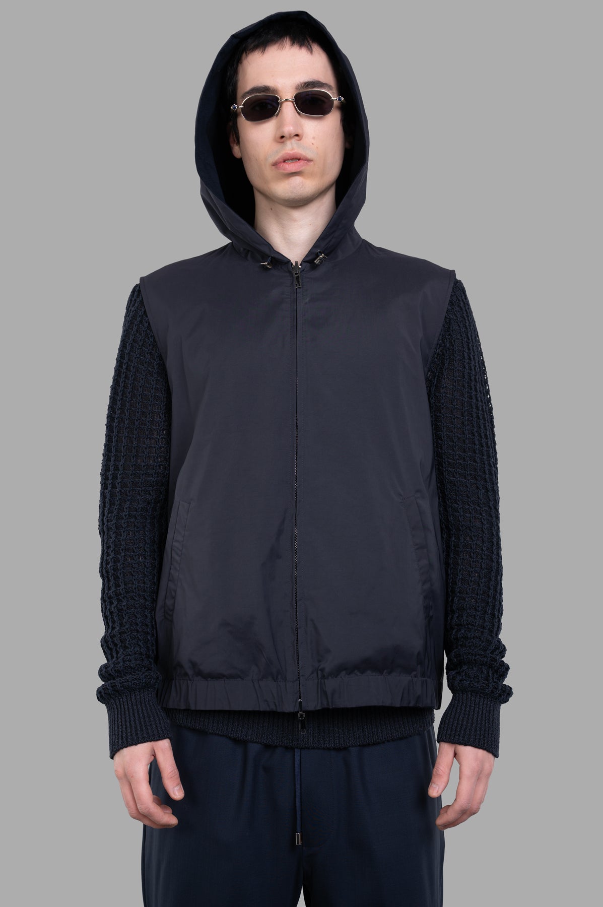AION Hooded Vest Jacket in navy, featuring a stylish hood and textured sleeves, perfect for seasonal layering.