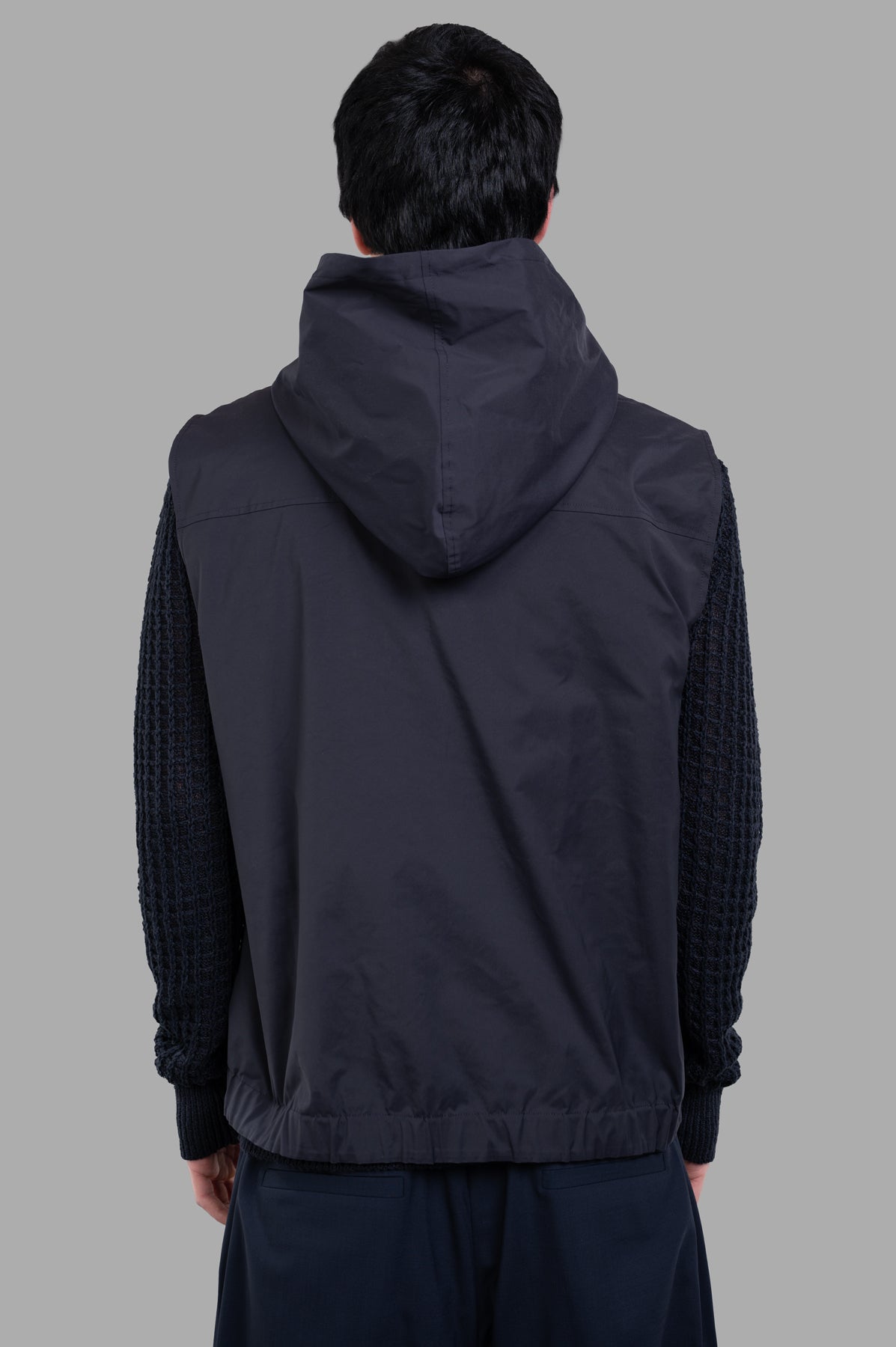 AION Hooded Vest Jacket in navy, showcasing a back view with textured sleeves, perfect for stylish seasonal layering.
