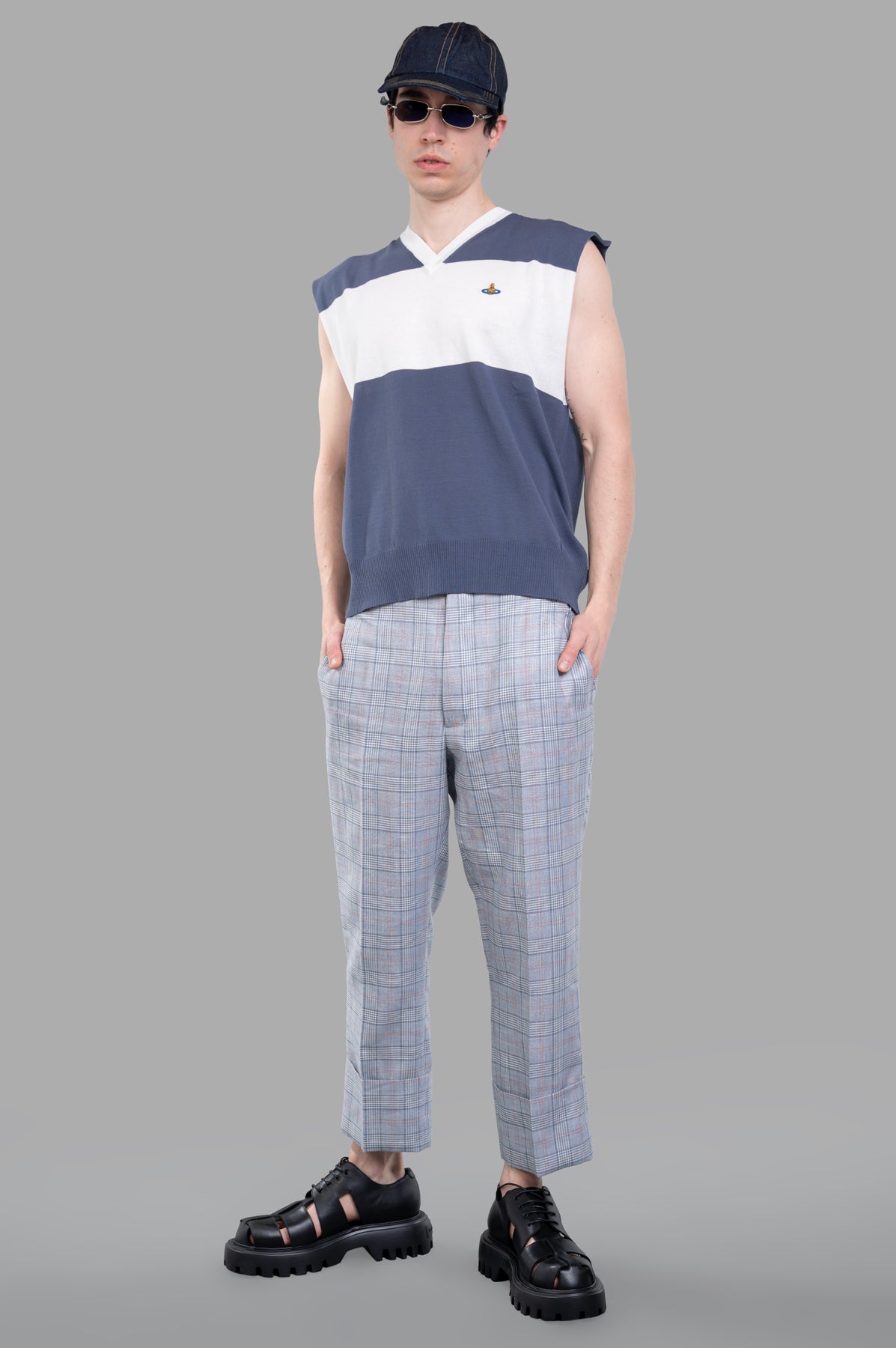 Vivienne Westwood Striped Sweater Vest showcases V-neck design in blue/white with orb logo, on-model front view.