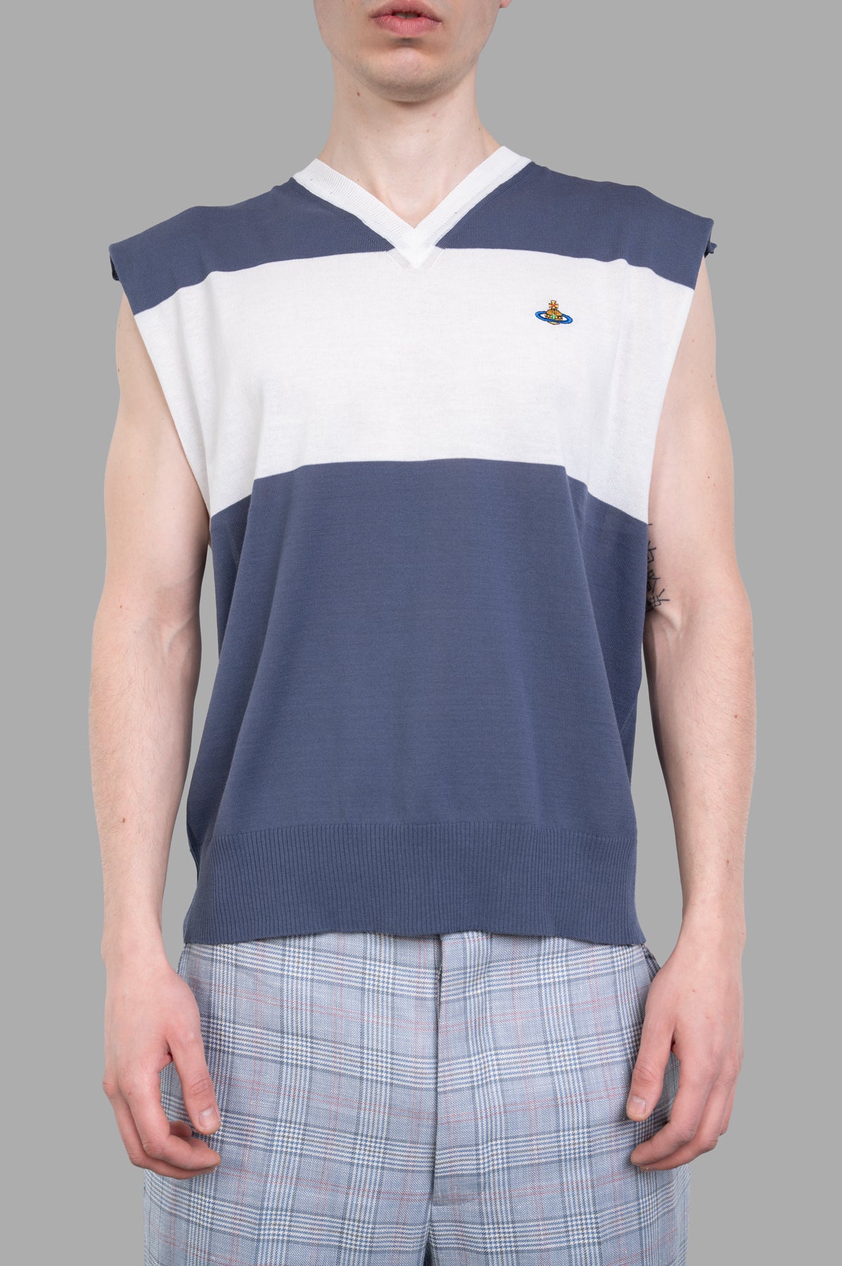 Vivienne Westwood Striped Sweater Vest in blue and white, showcasing a V-neck design worn by a model, made of 100% cotton.