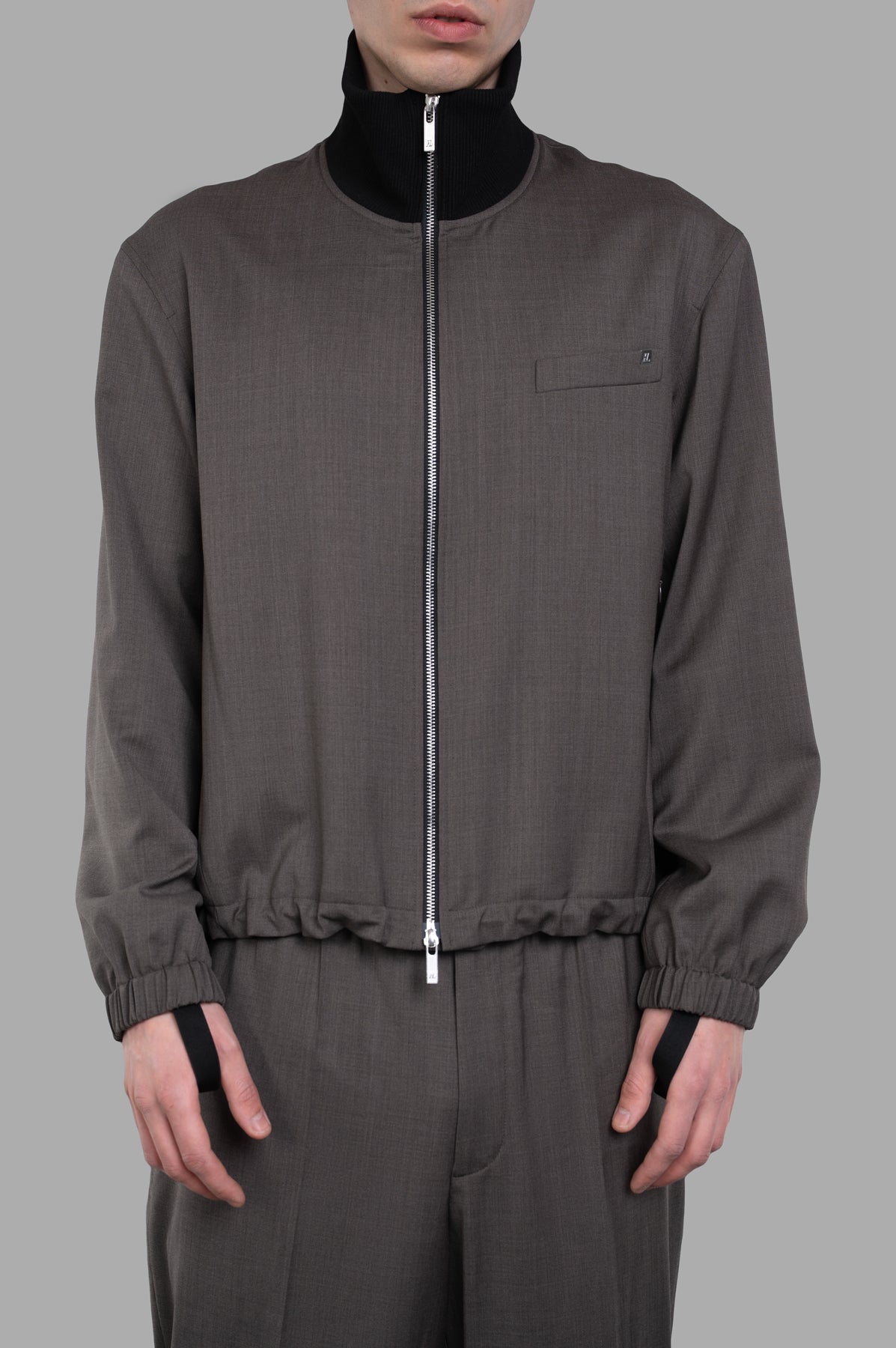 Helmut Lang Relaxed Wool Bomber jacket in brown, featuring ribbed collar and zip-up design, modeled front view.