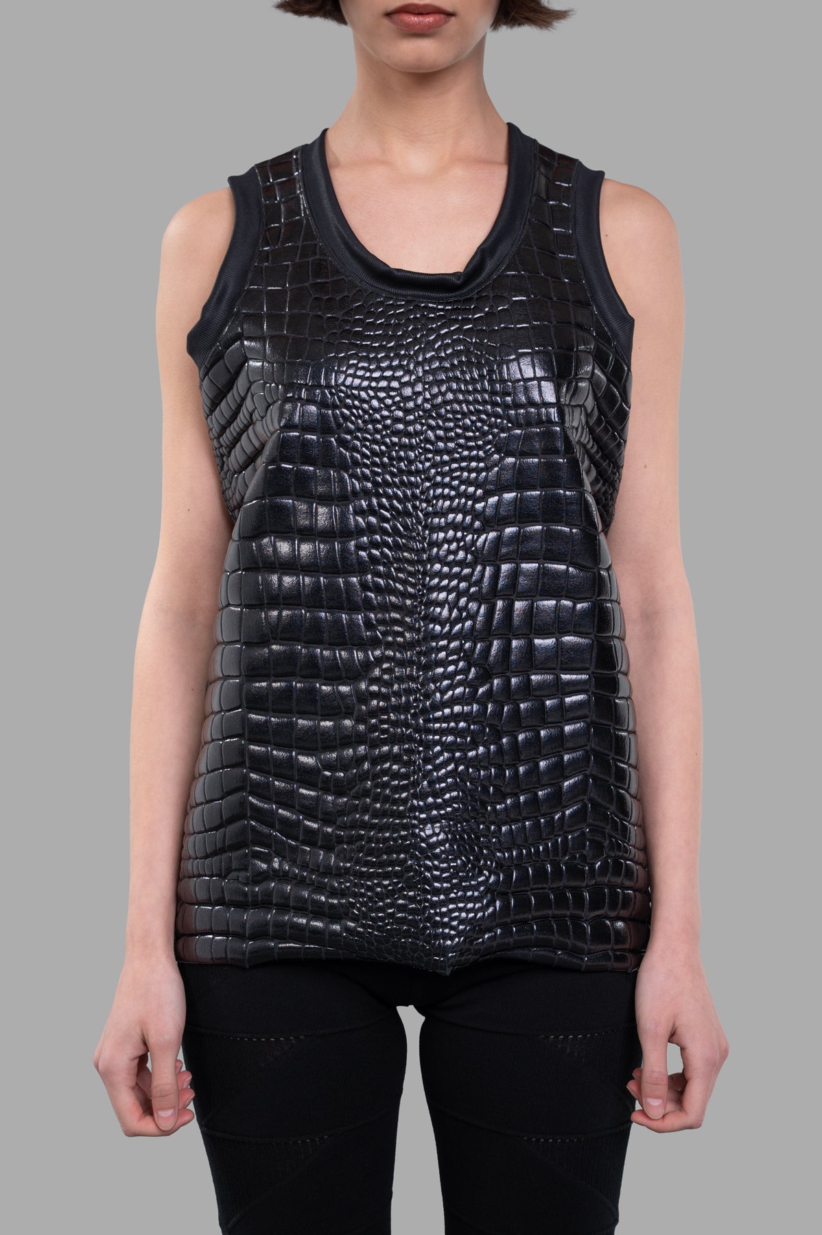 **Alt Text:** Junya Watanabe Crocodile-embossed Top in black, showcasing a sleek sleeveless design and textured fabric detail.
