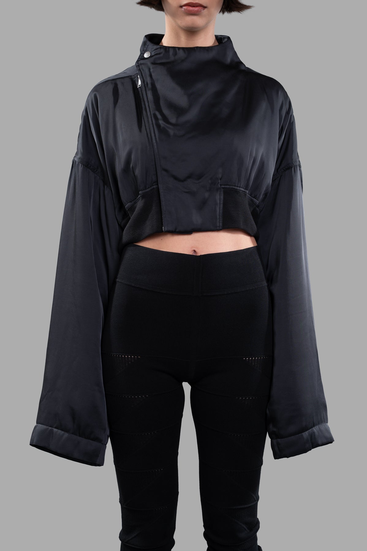 Rick Owens Anthem Flight Jacket displayed on model, showcasing cropped design and oversized sleeves in sleek black fabric.