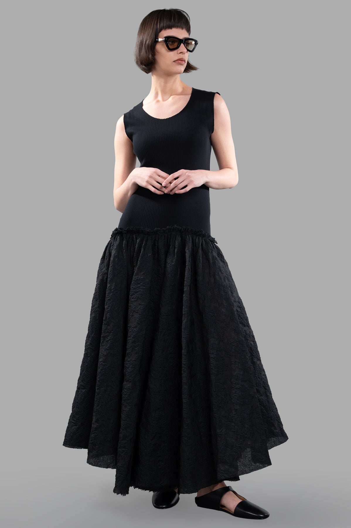 Marc Point Long Bustier Dress shown on model, featuring a sleeveless maxi design with an asymmetrical hem in elegant black.