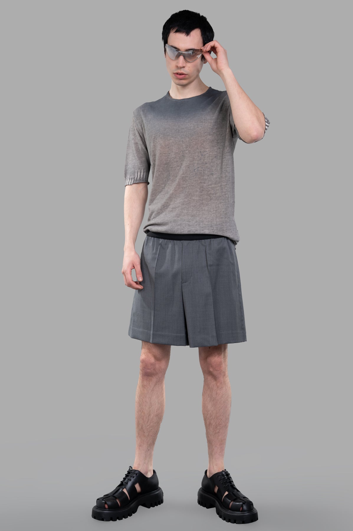 Helmut Lang Pull-On Car Shorts in grey on model, showcasing tailored satin logo jacquard with hidden side pockets.
