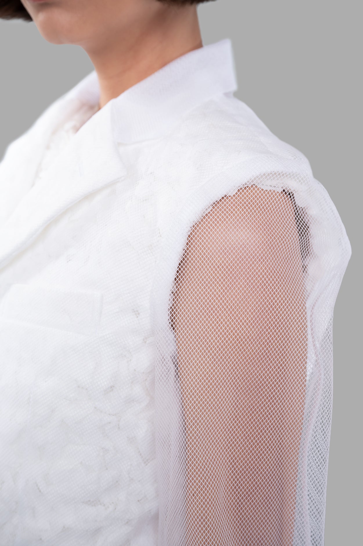 Comme des Garçons Flower-embroidery Jacket, showcasing detailed tulle overlay and tailored fit, side view on model.