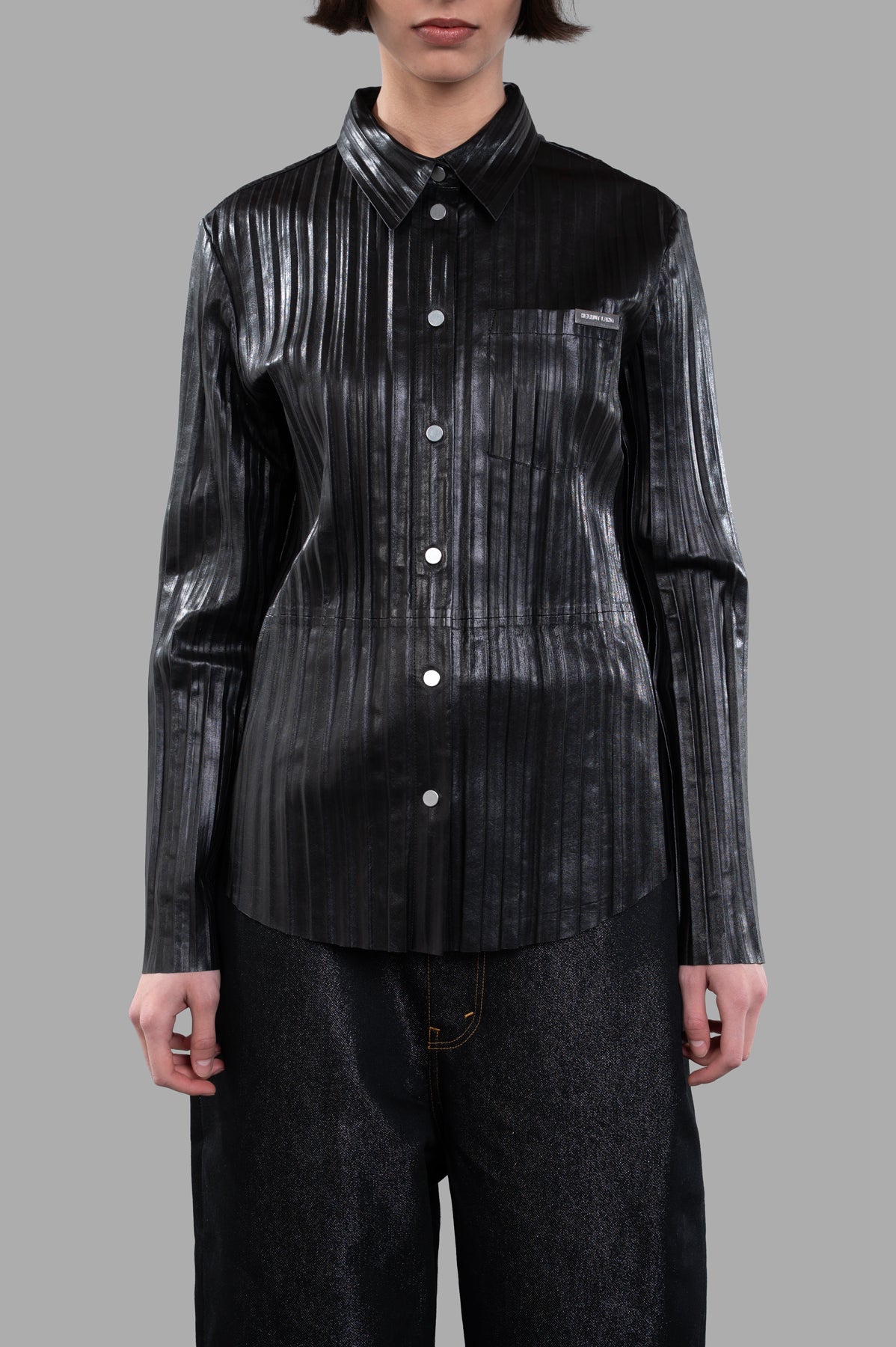 Helmut Lang Pleated Leather Shirt in black, showcasing the front detail of a relaxed button-up with sleek pleats.