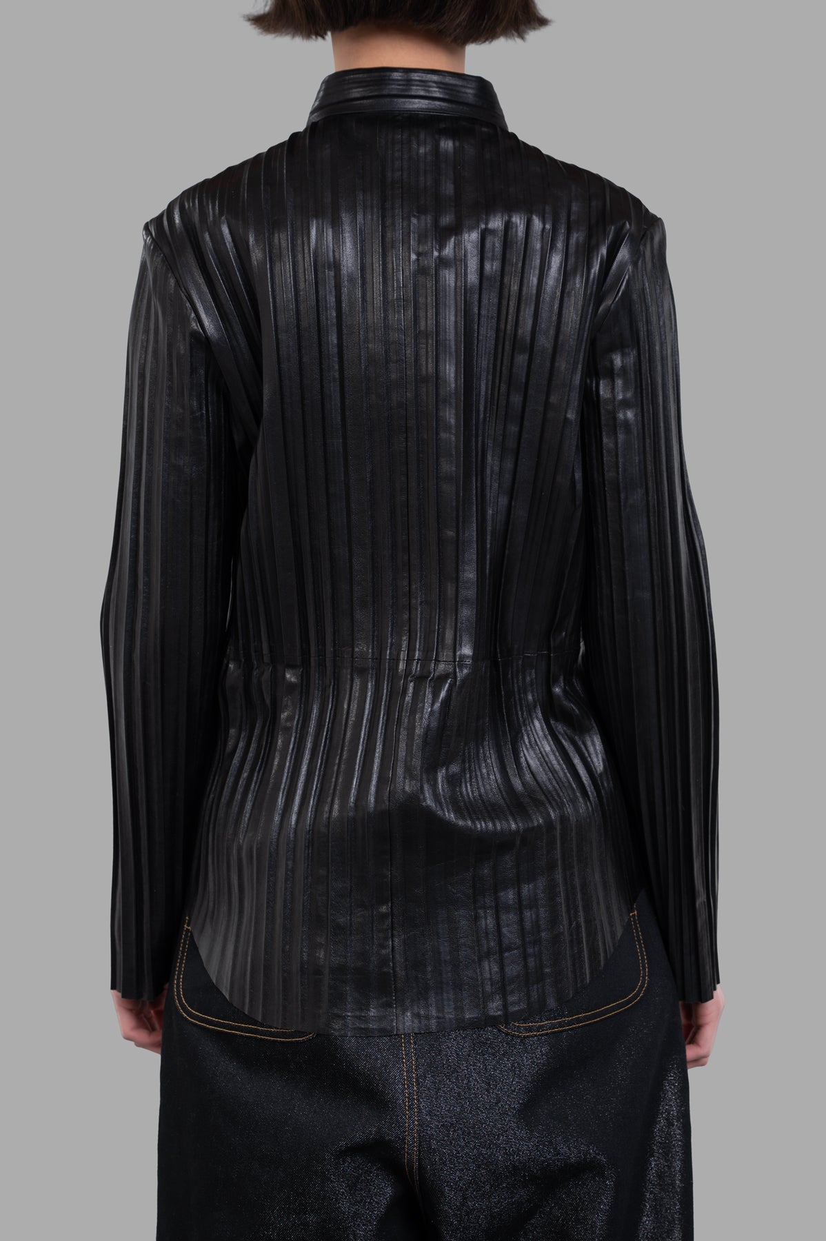 Helmut Lang Pleated Leather Shirt featuring a relaxed fit and a detailed back view with textured pleating in black leather.