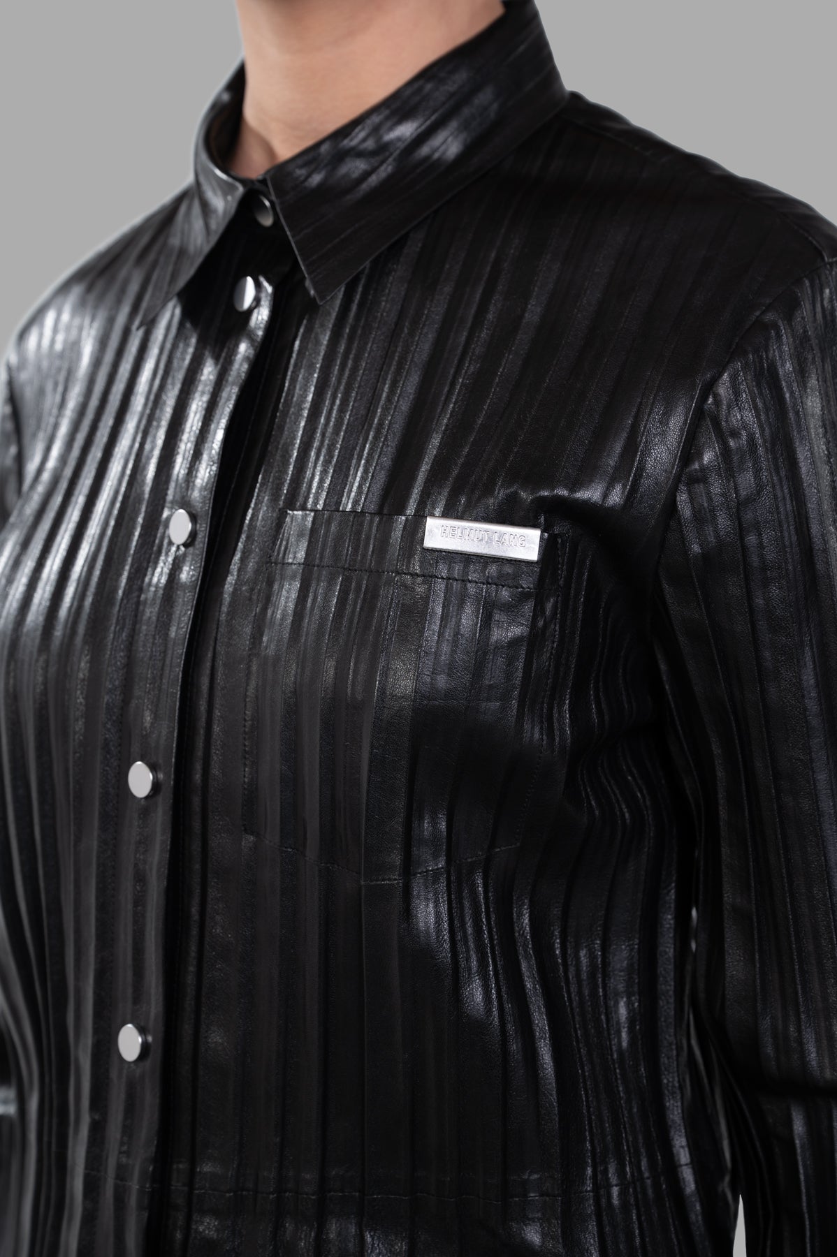 Helmut Lang Pleated Leather Shirt, relaxed fit in black pleated leather, showcasing button-front and signature pocket detail.
