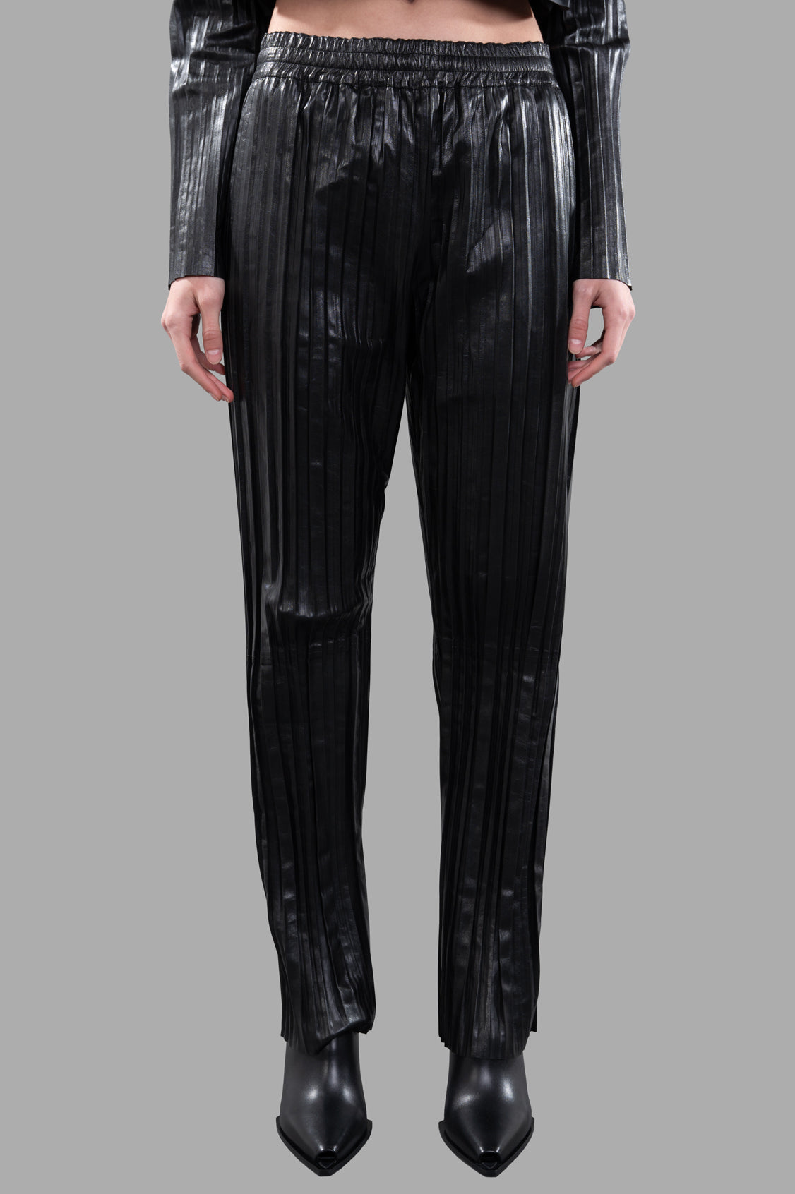 Helmut Lang Pleated Leather Car Trousers in black, showcasing a relaxed fit with vertical pleats and an elastic waistband.