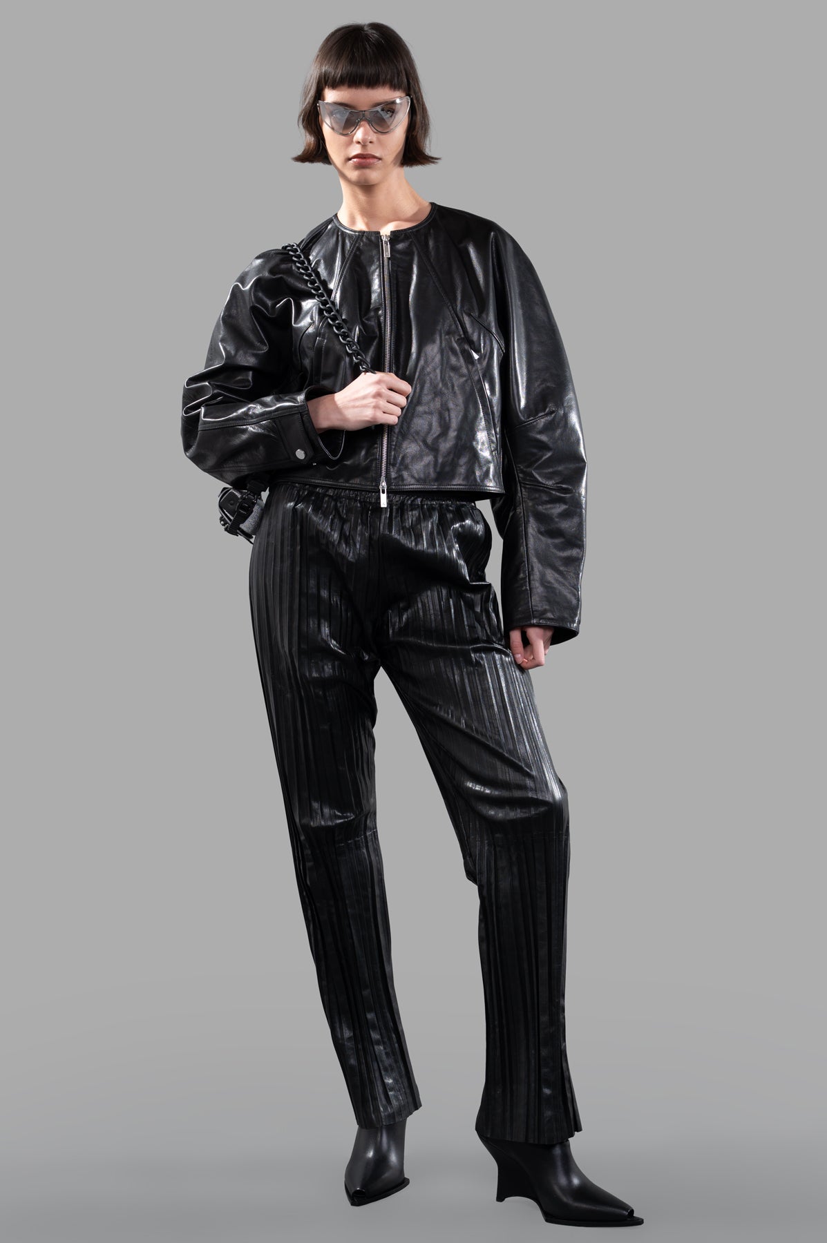 Helmut Lang Articulated Leather Jacket, front view on model, paired with matching pants and accessories.