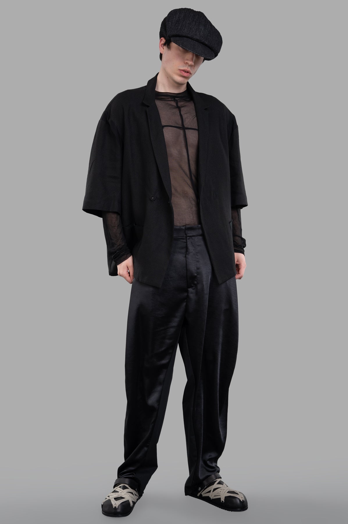 Giovanni Cavagna Cropped-sleeve Blazer, front view on model, black with 3/4 sleeves and thin lapels.