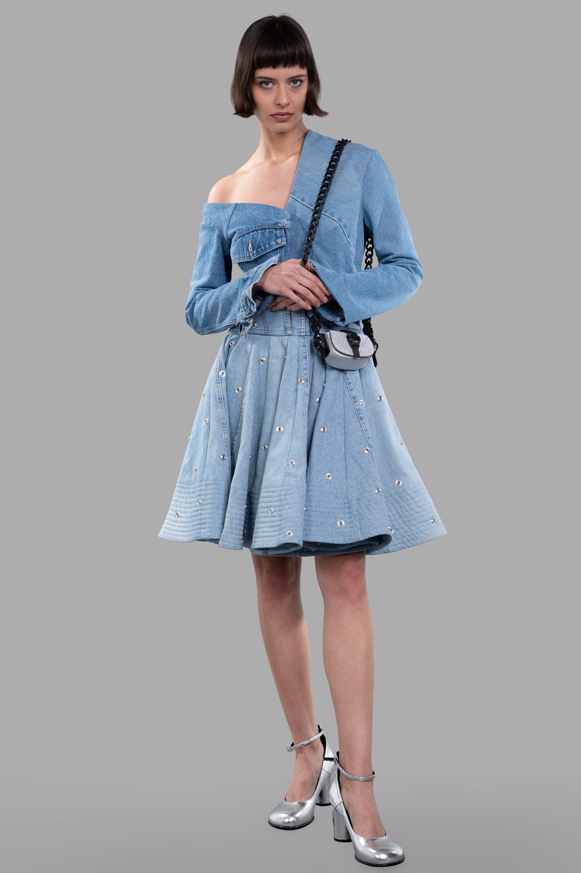 A.W.A.K.E. MODE Recycled Denim Skirt in blue, front view on model, high-waisted with snap button details and full silhouette.