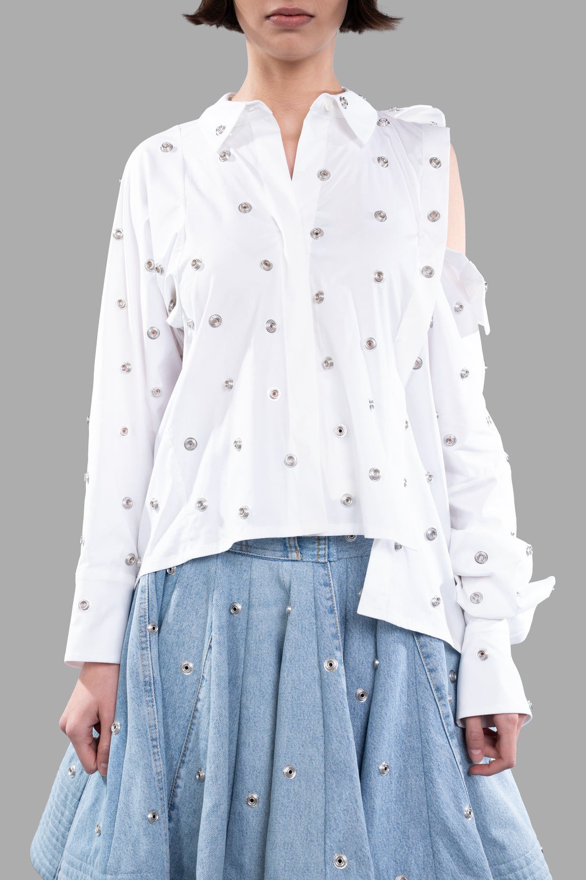 A.W.A.K.E. MODE Studded Double-collar Shirt in white, showcasing silver grommet details, cold-shoulder cutout, on model.