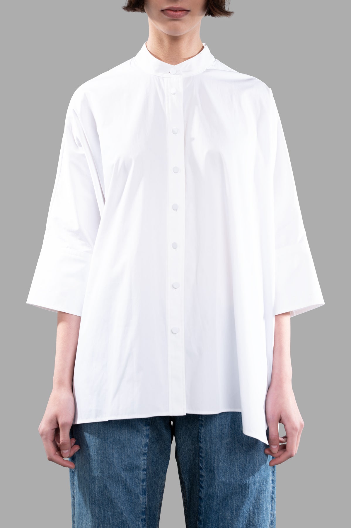 Joseph Oversized Poplin Shirt in white, featuring a relaxed fit and button-down details, styled with denim for a chic look.