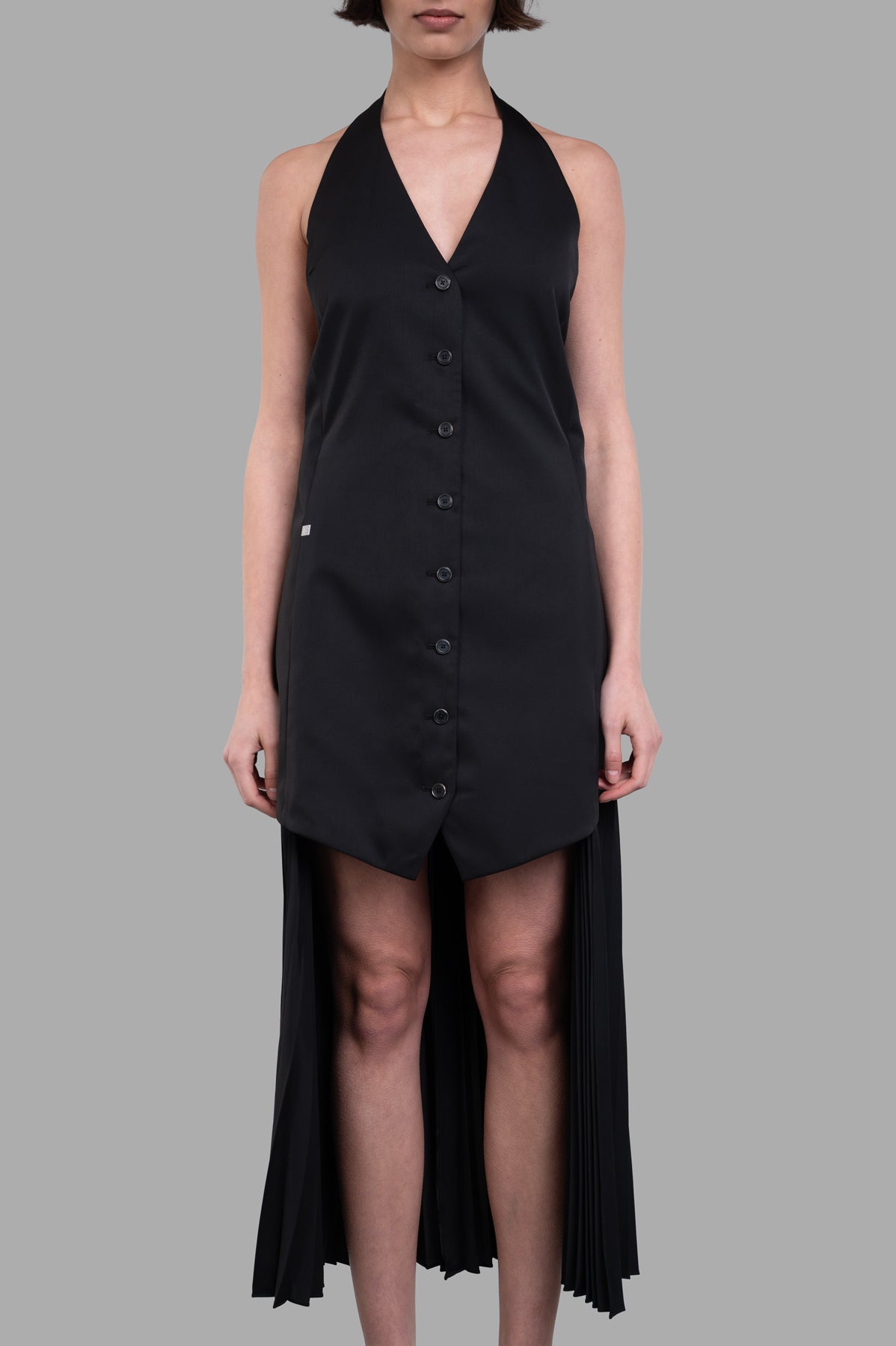 **Alt Text:** Helmut Lang Halter Vest Dress featuring a sleek front and pleated skirt, styled with buttons and a deep neckline.