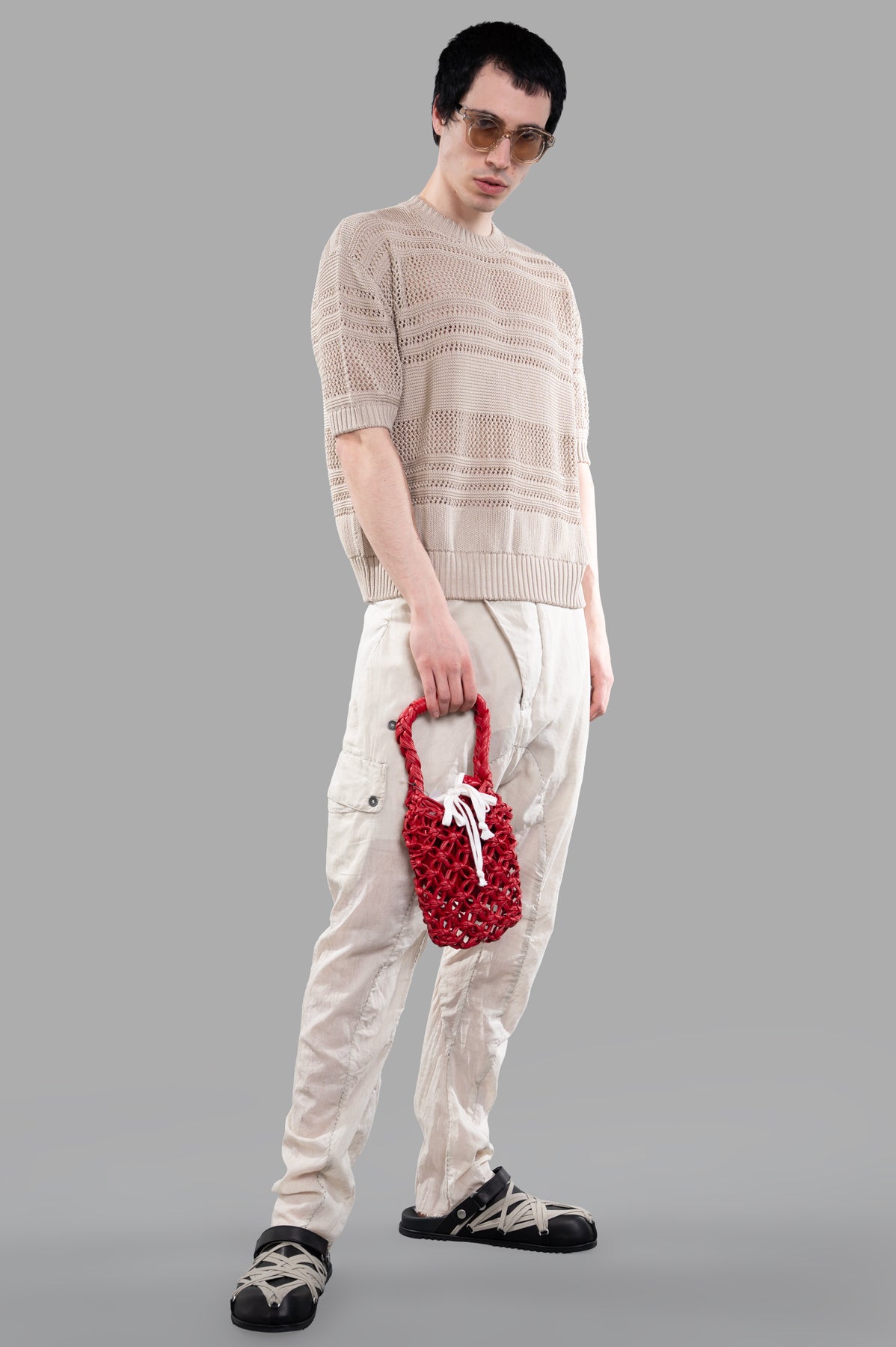 Masnada ecru drop-crotch pants on model, featuring elastic waist with drawstring, crafted from 100% cotton for comfort.