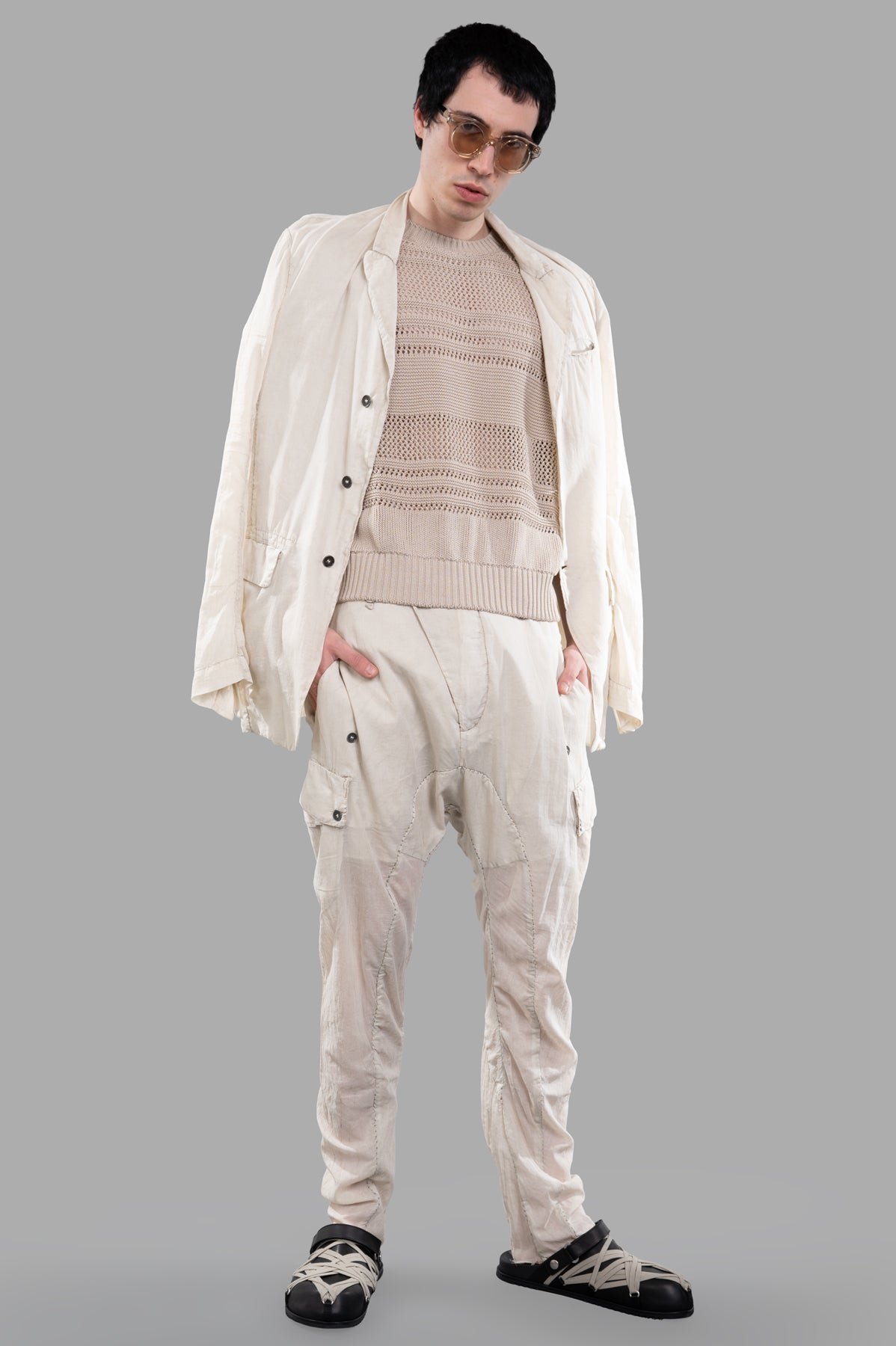 AION beige perforated-mesh T-shirt front view on model with open jacket, showcasing ribbed crewneck and short sleeves.