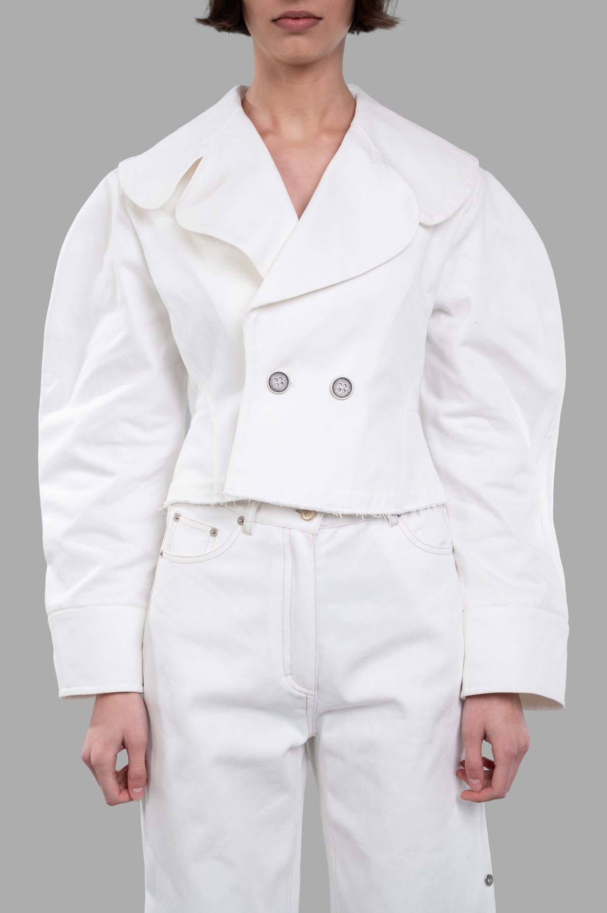 Sehnsucht Atelier Double-breasted Cropped Jacket with wide lapels, worn on-model, showcasing its bold silhouette in white cotton.