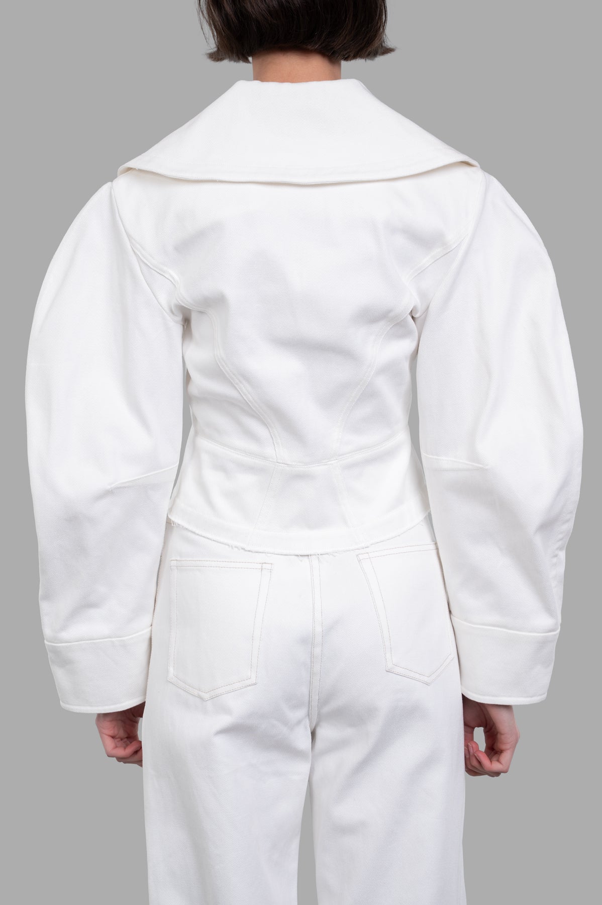 Sehnsucht Atelier Double-breasted Cropped Jacket shown from the back, featuring wide lapels and a fitted silhouette in white.
