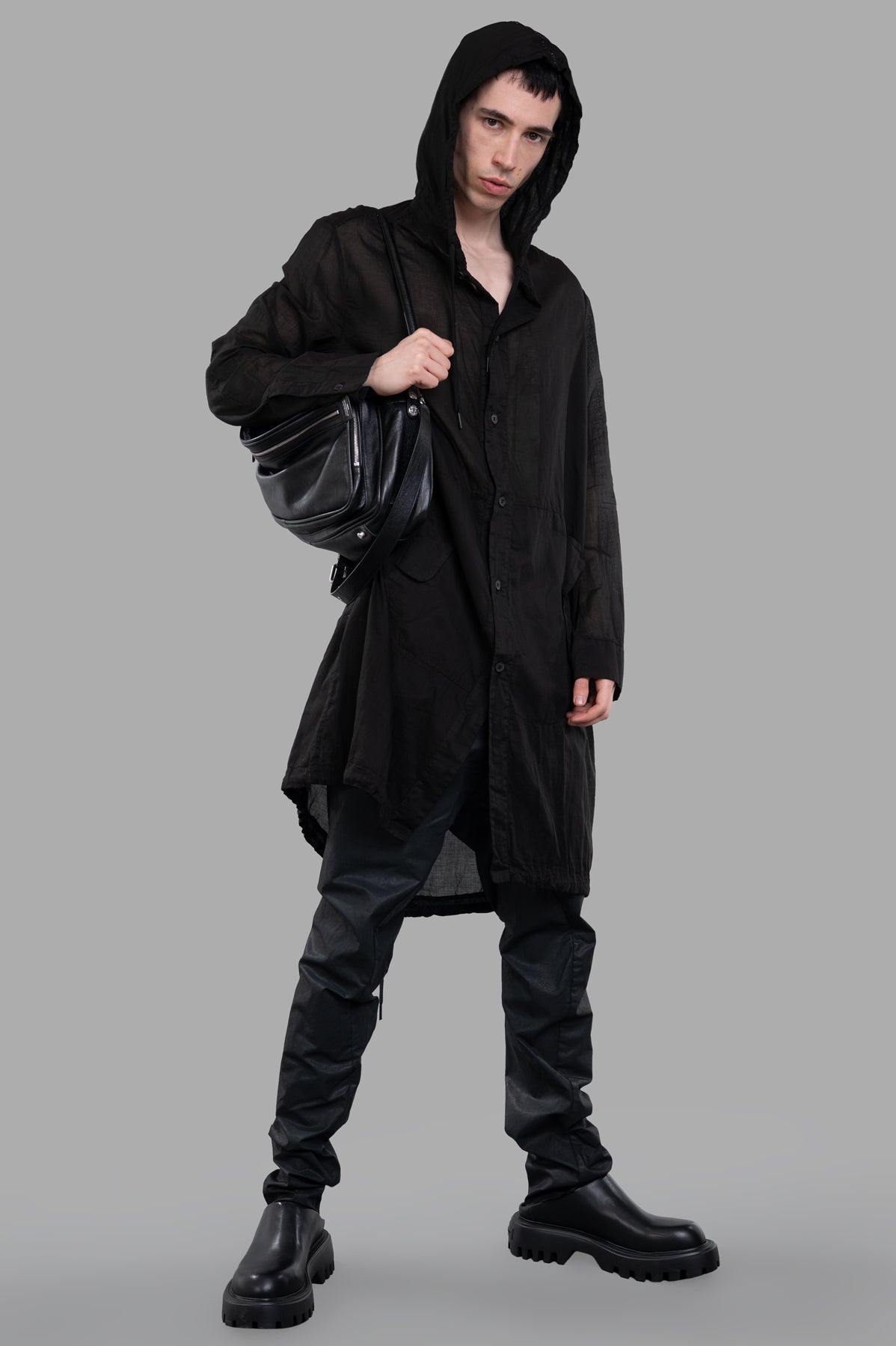 Masnada Sheer Parka in black, front view on-model, showcasing its lightweight, transparent design with hood.