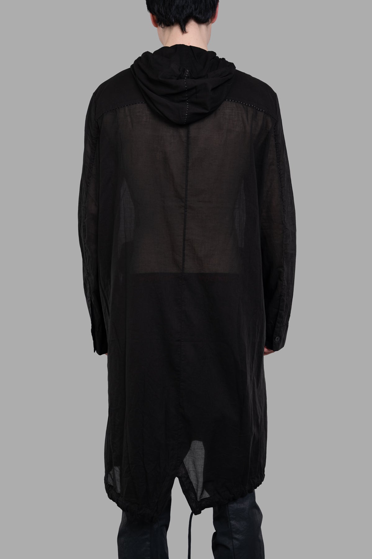 Masnada Sheer Parka showing the back view of a lightweight transparent hooded jacket in black, featuring adjustable.