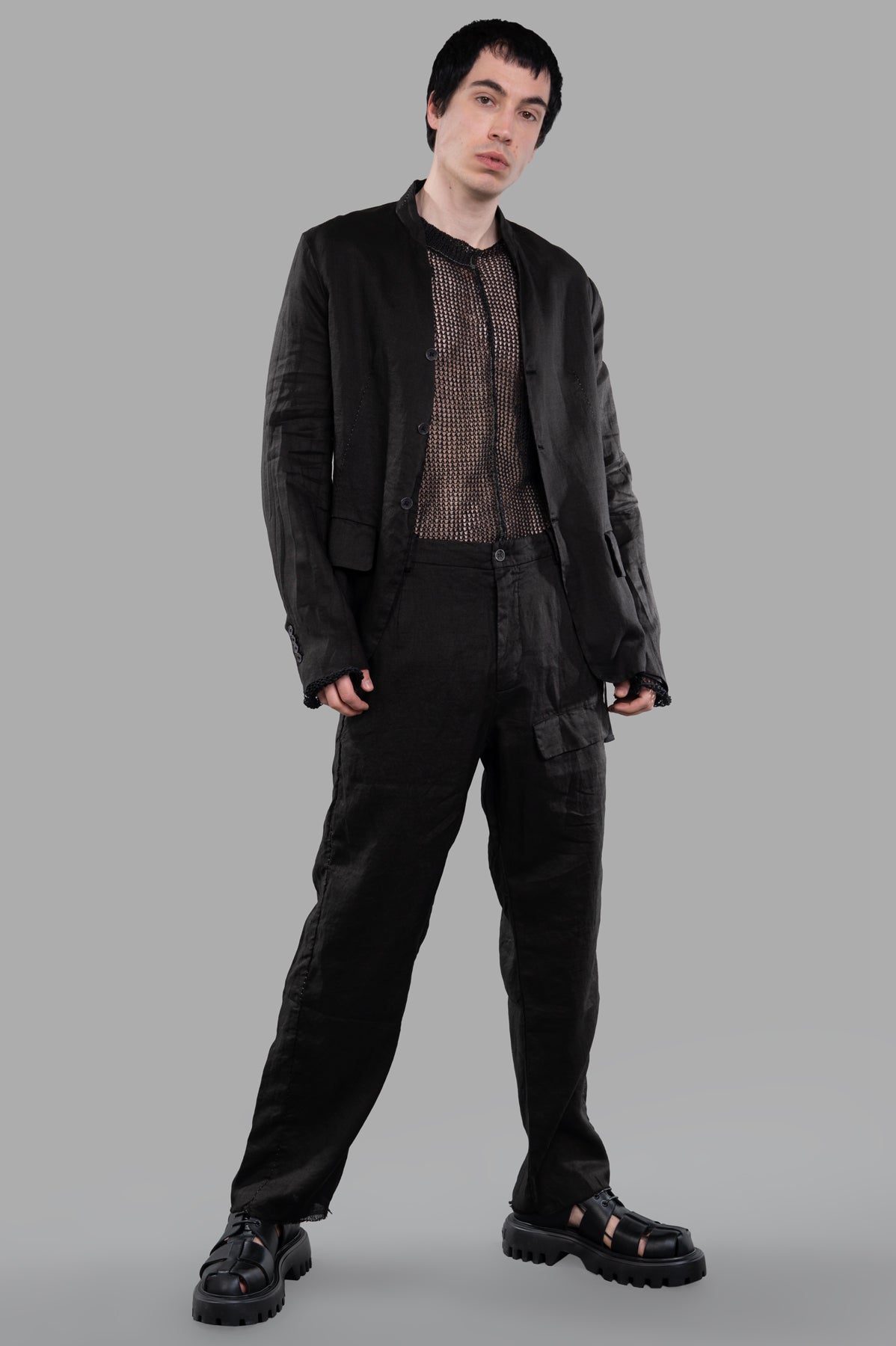 Masnada Single-breasted Blazer in black, front view, collarless with side flap pockets and back vent, worn on a model.