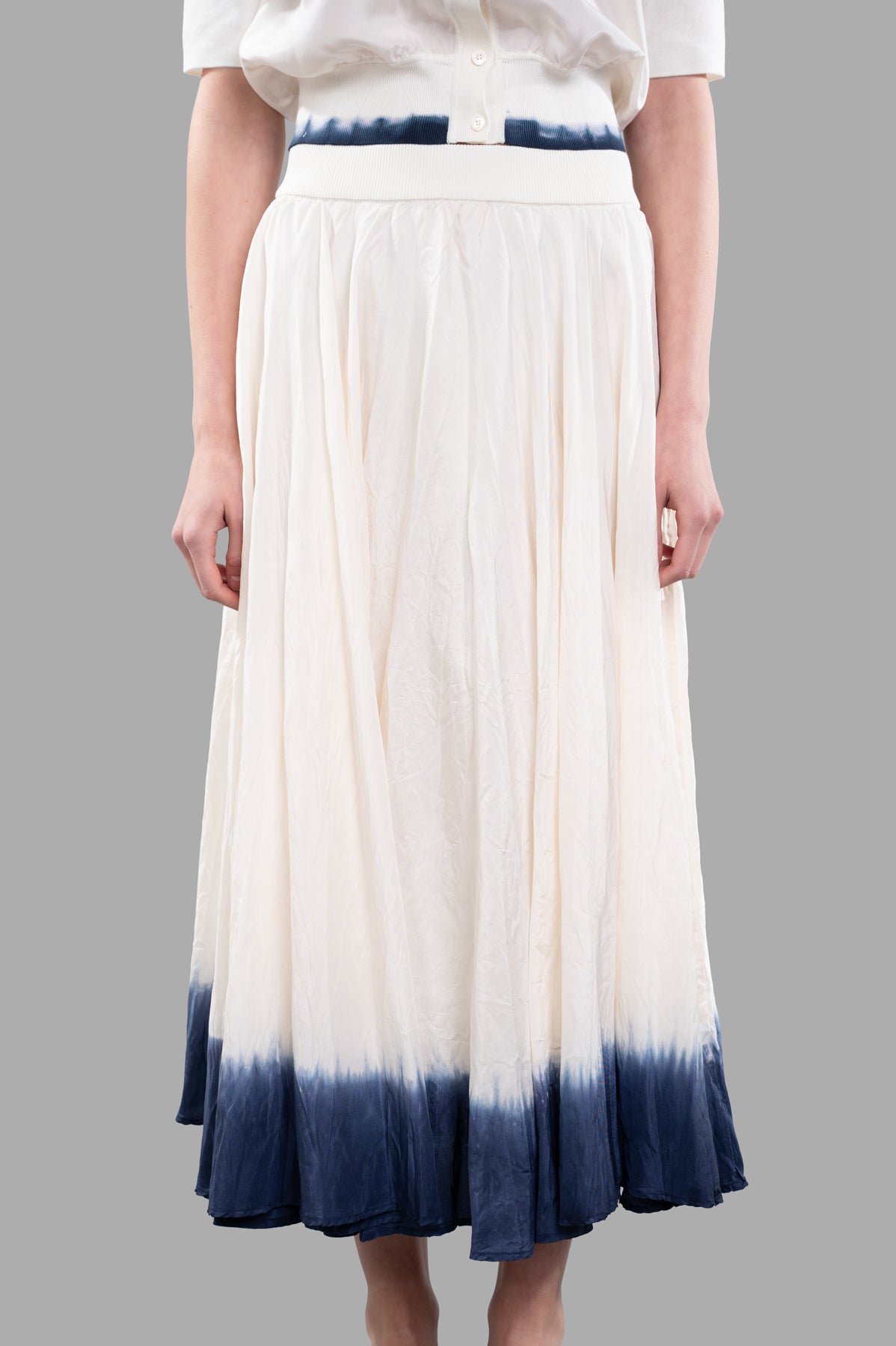 Joseph. Gradient Skirt in ecru silk, showcasing a knitted waistband and tie-dye hemline, displayed on a model.